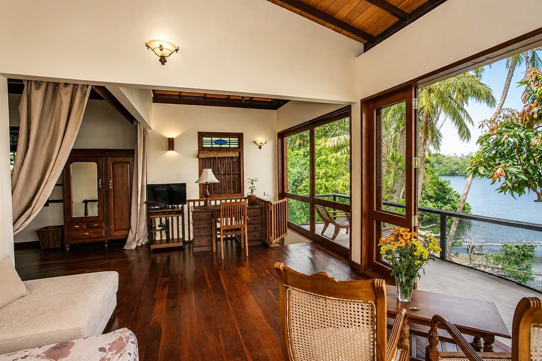 Koggala Lake bedroom with cane chairs and lake view