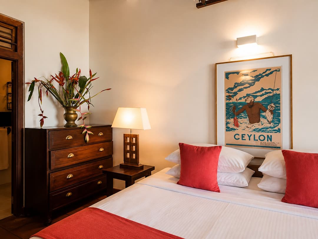 Koggala Lake bedroom with red pillows and dresser