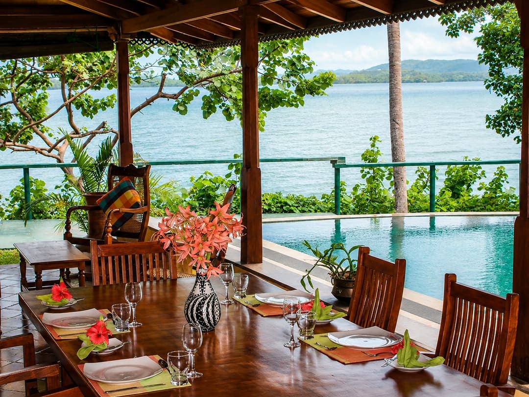 Koggala Lake dining table with flowers and lake view