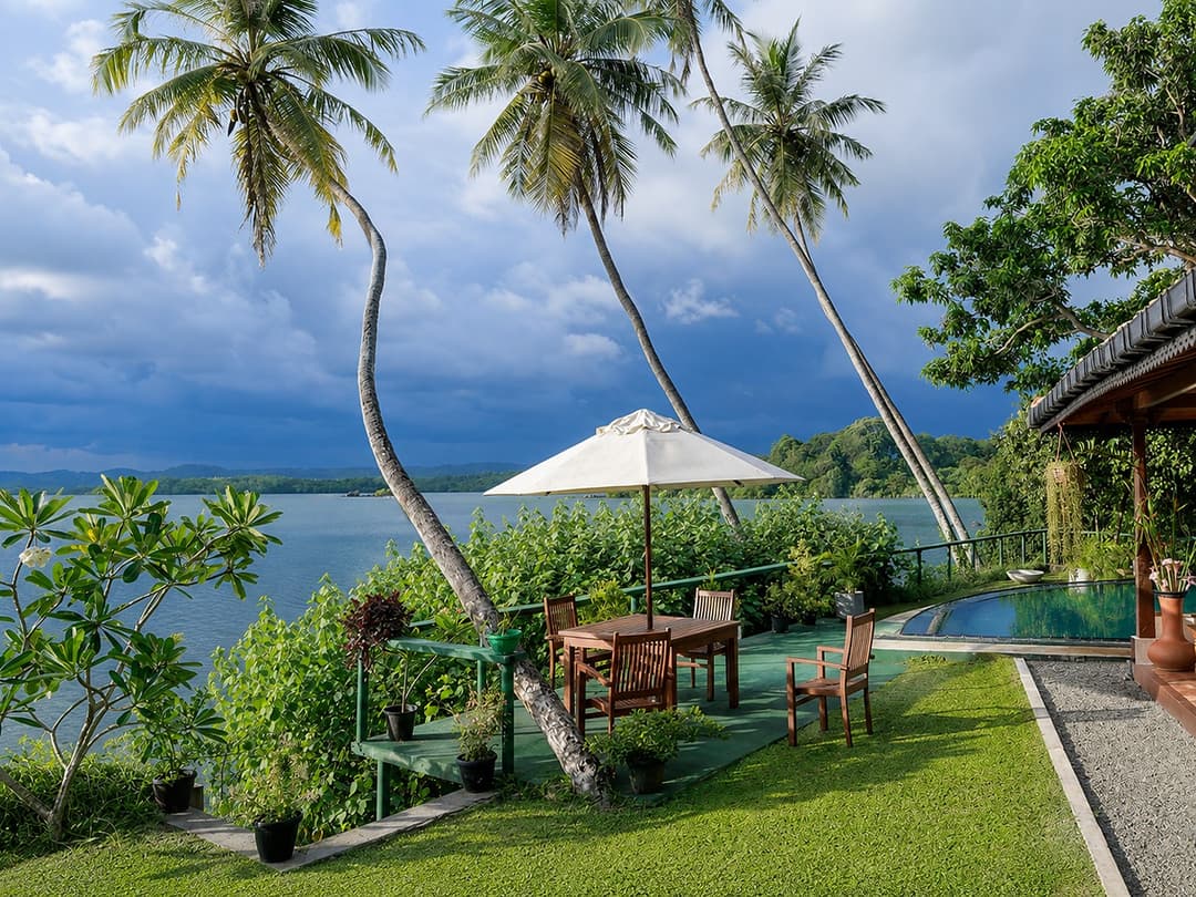 Koggala Lake garden furniture under a storm sky