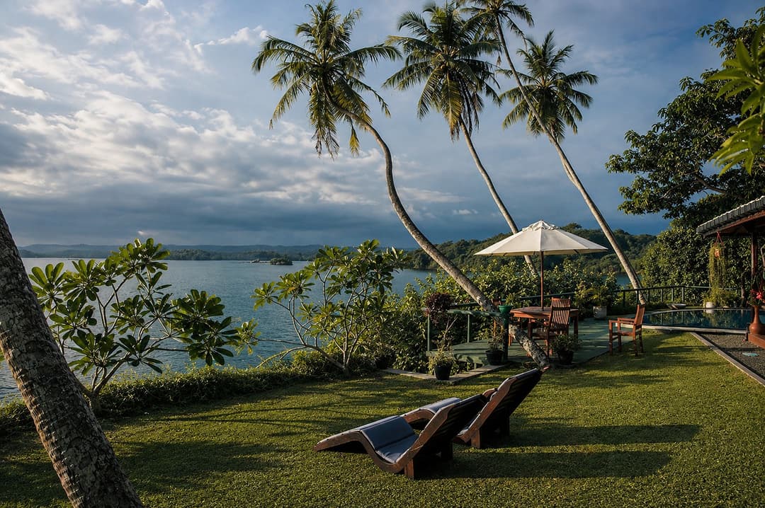 Koggala Lake garden furniture with umbrella at dusk