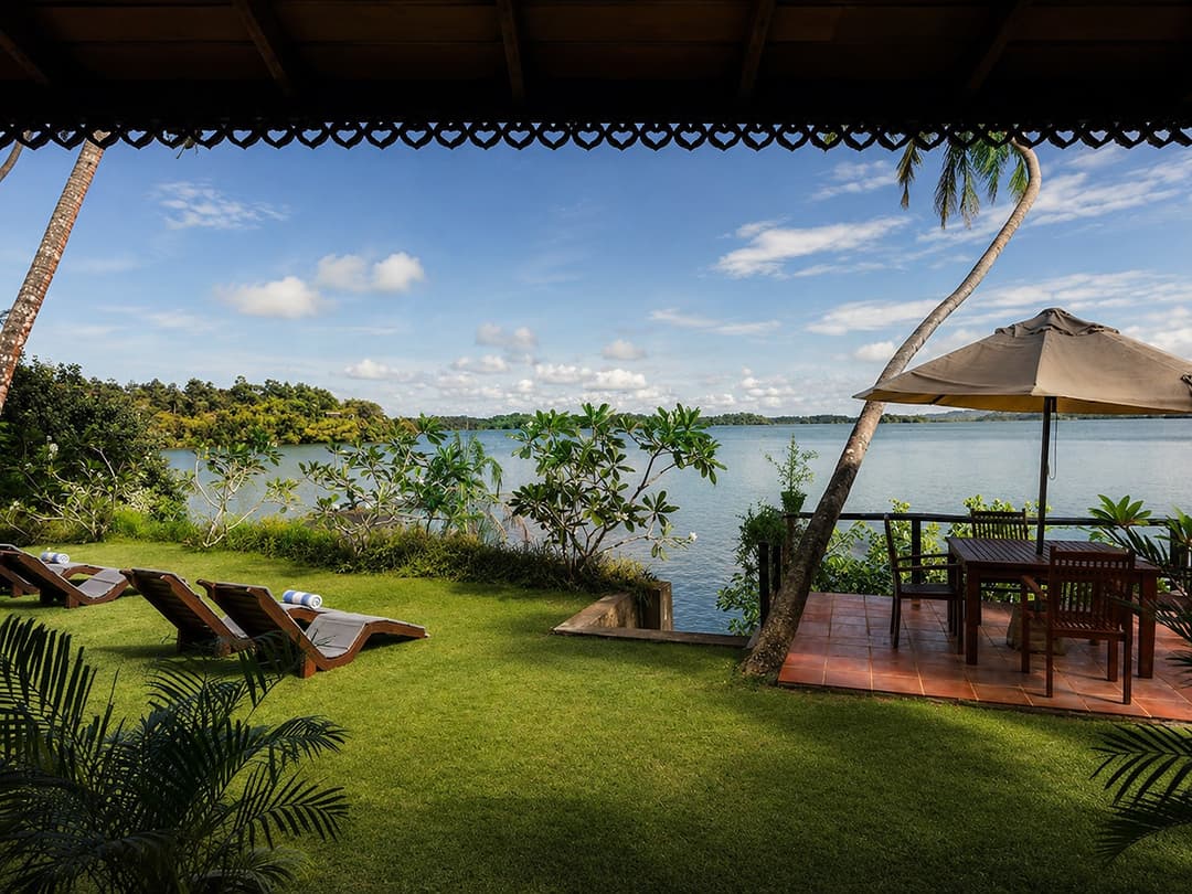 Koggala Lake garden lawn with loungers and umbrella