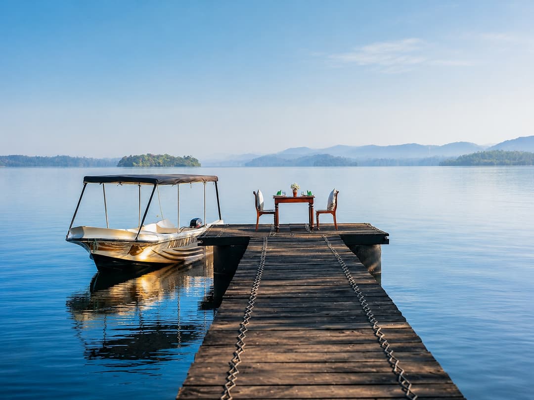 Koggala Lake jetty with boat at dusk