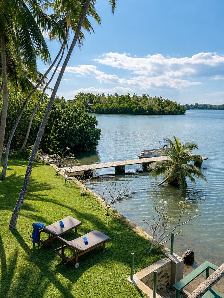 Koggala Lake jetty with loungers at dusk