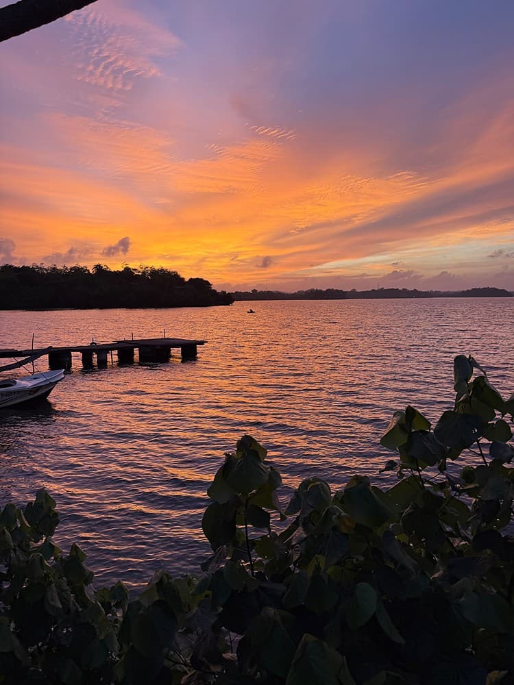 Koggala Lake jetty with boat at sunset