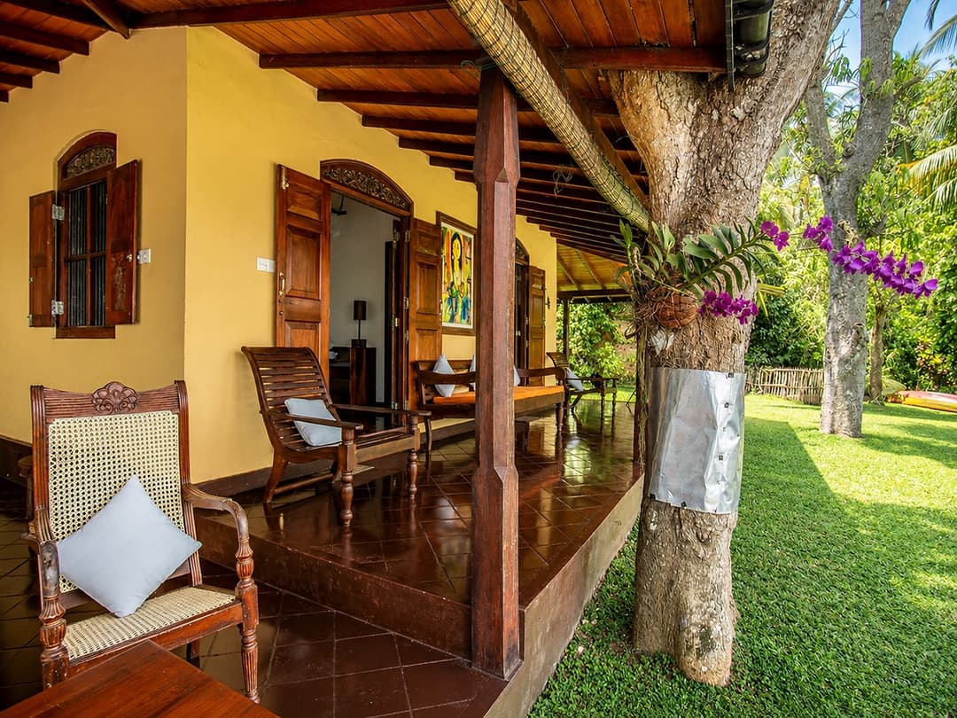Koggala Lake veranda dining chairs with garden view
