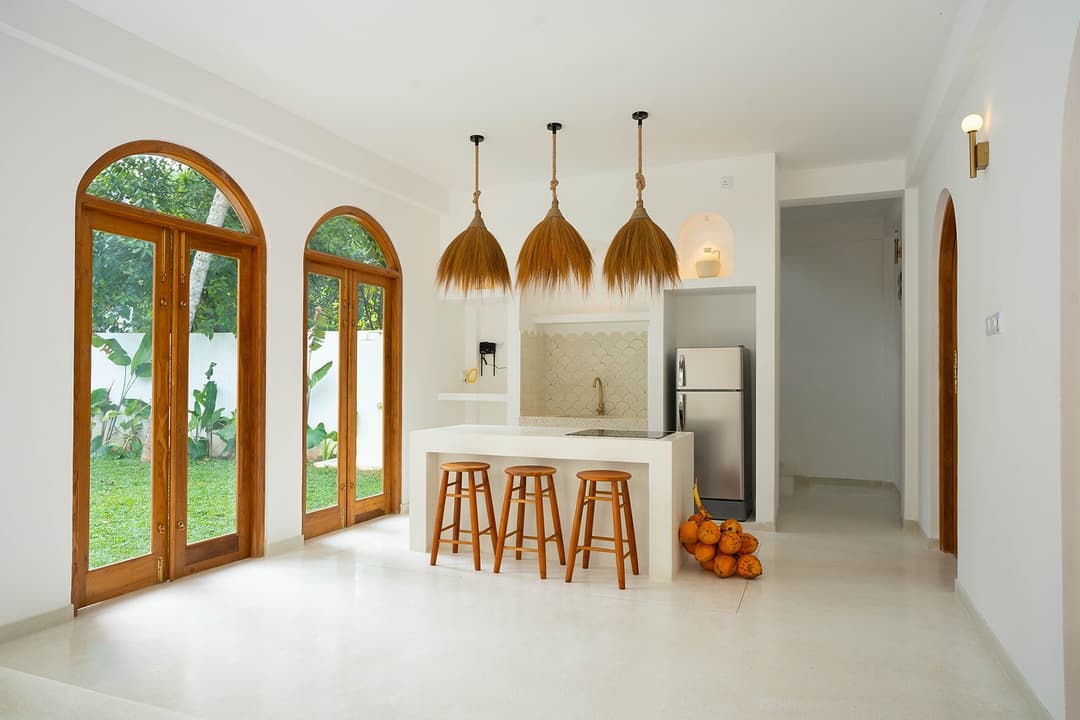 Ahangama living room with arched doorway to pool
