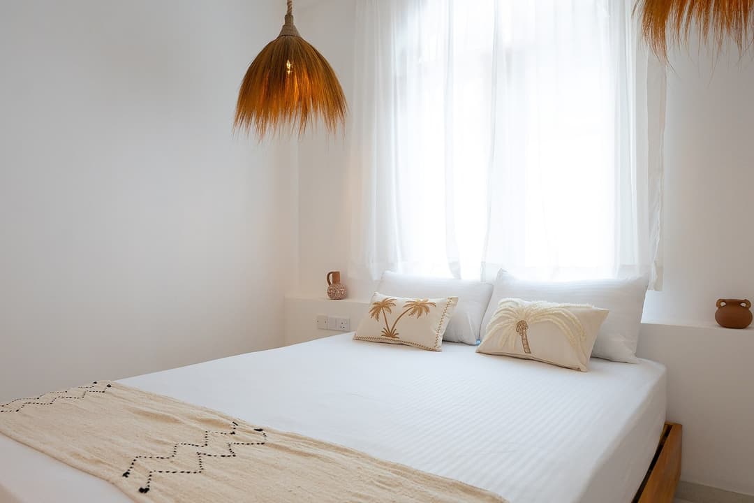 Ahangama bedroom with white bed and sheer curtain