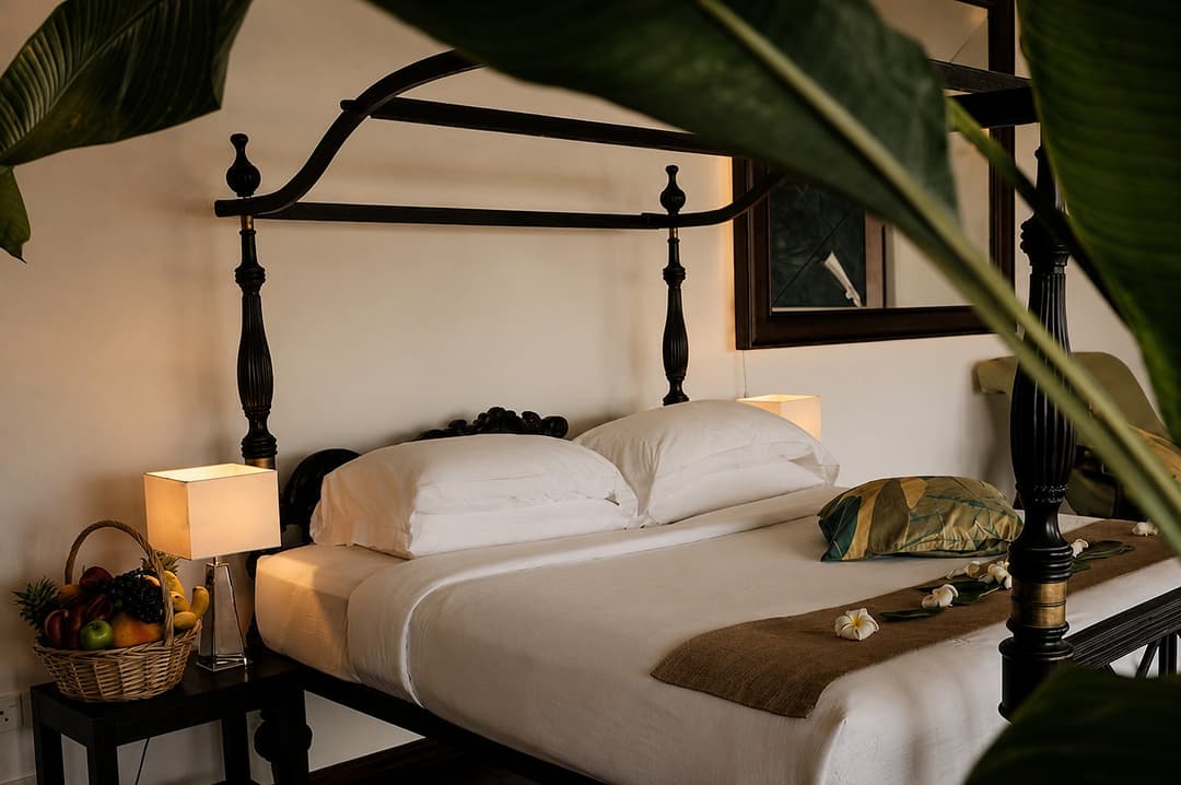 Mirissa bedroom with four poster bed and fruit basket