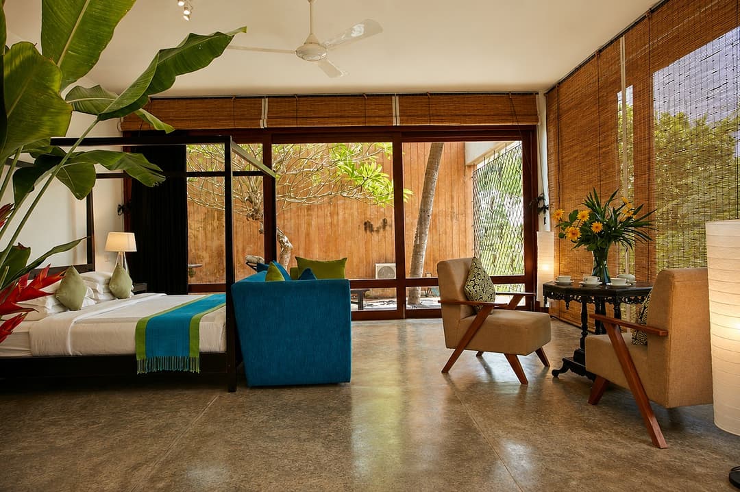 Mirissa bedroom with teal sofa and plant