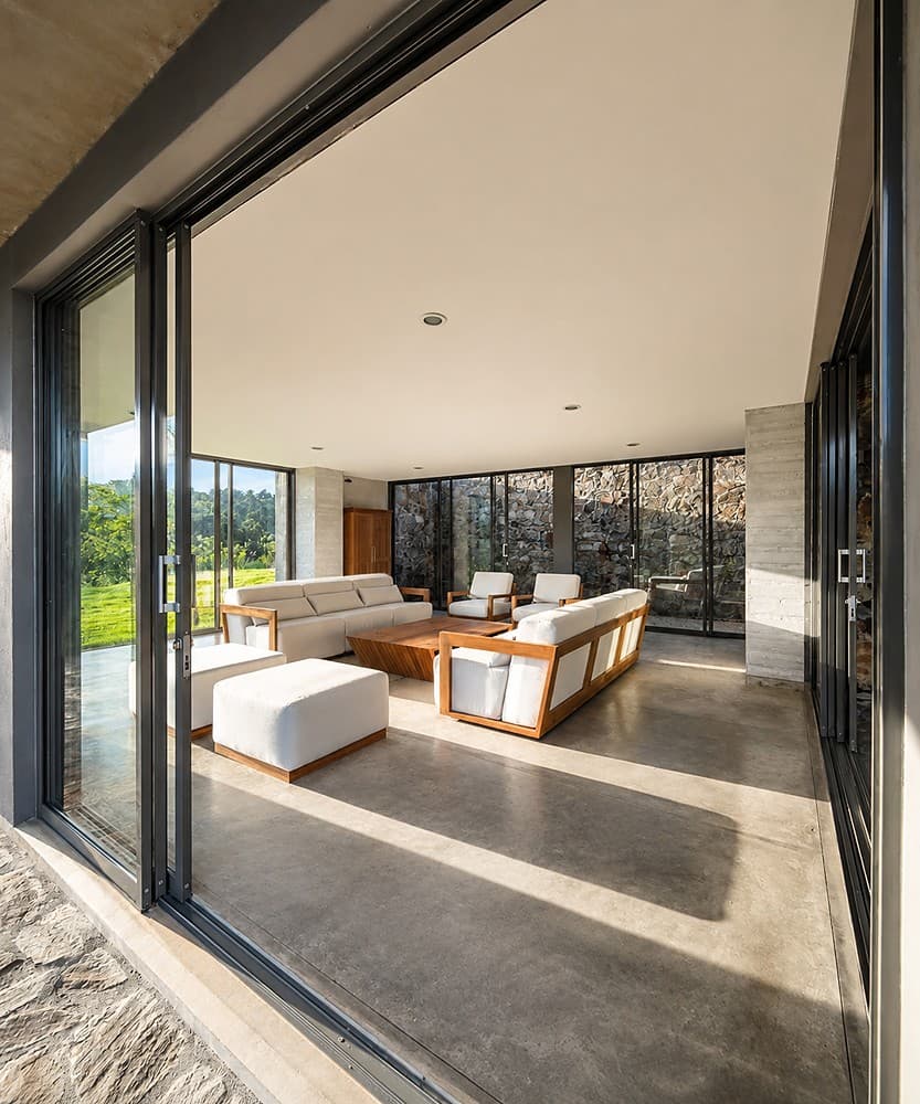 Digana living room with glass doors and lawn view