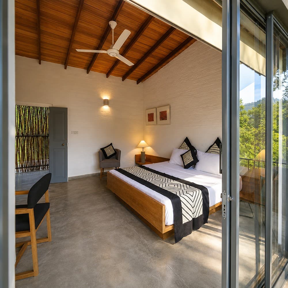 Digana bedroom with glass doors and wood ceiling