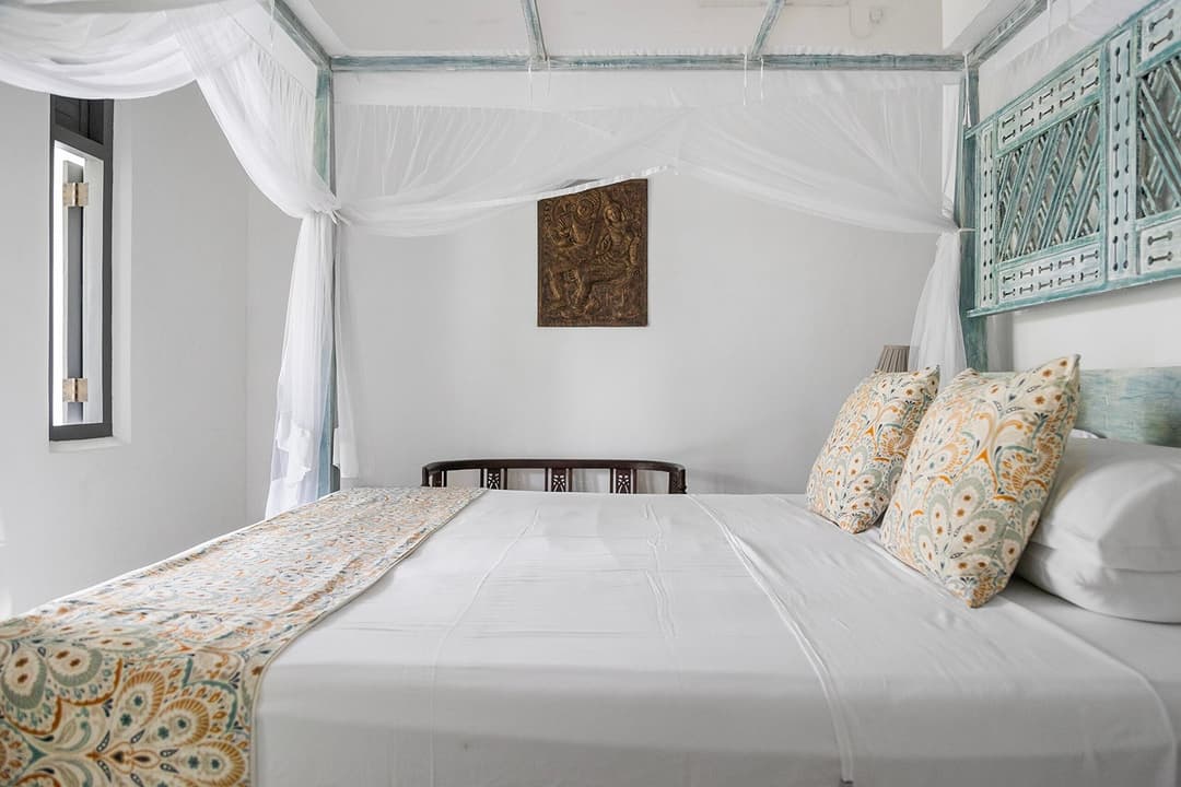 Ahangama bedroom with netted bed and wall art