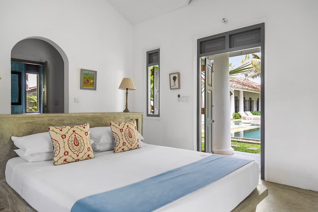 Ahangama bedroom with blue linen and pool doors