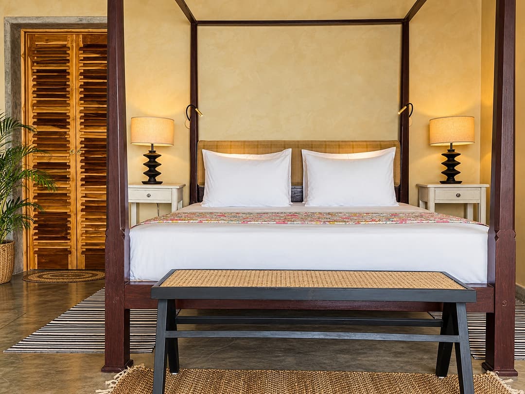 Villa Marisol bedroom with four poster bed and shutters