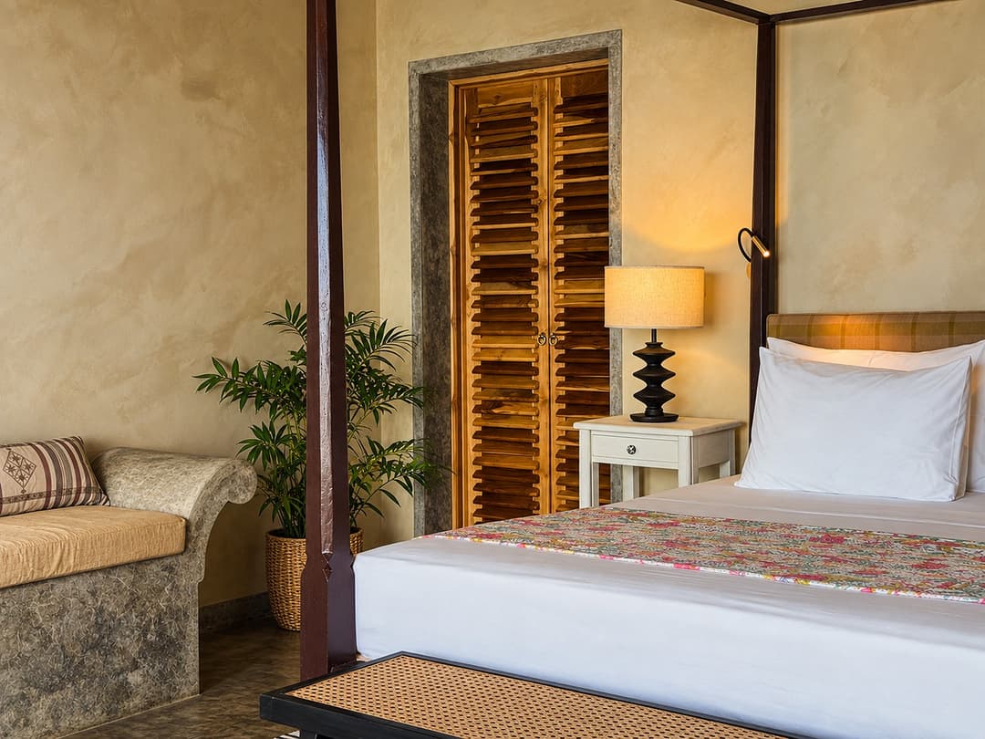 Villa Marisol bedroom four poster bed with wood shutters