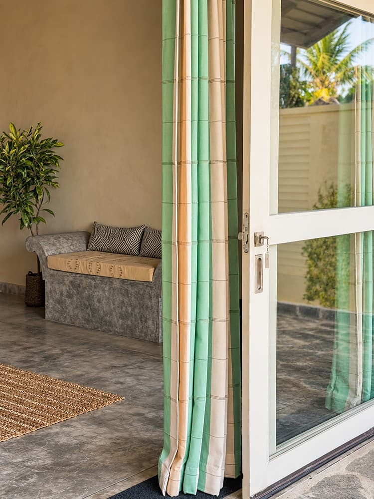 Villa Marisol veranda daybed with striped curtain
