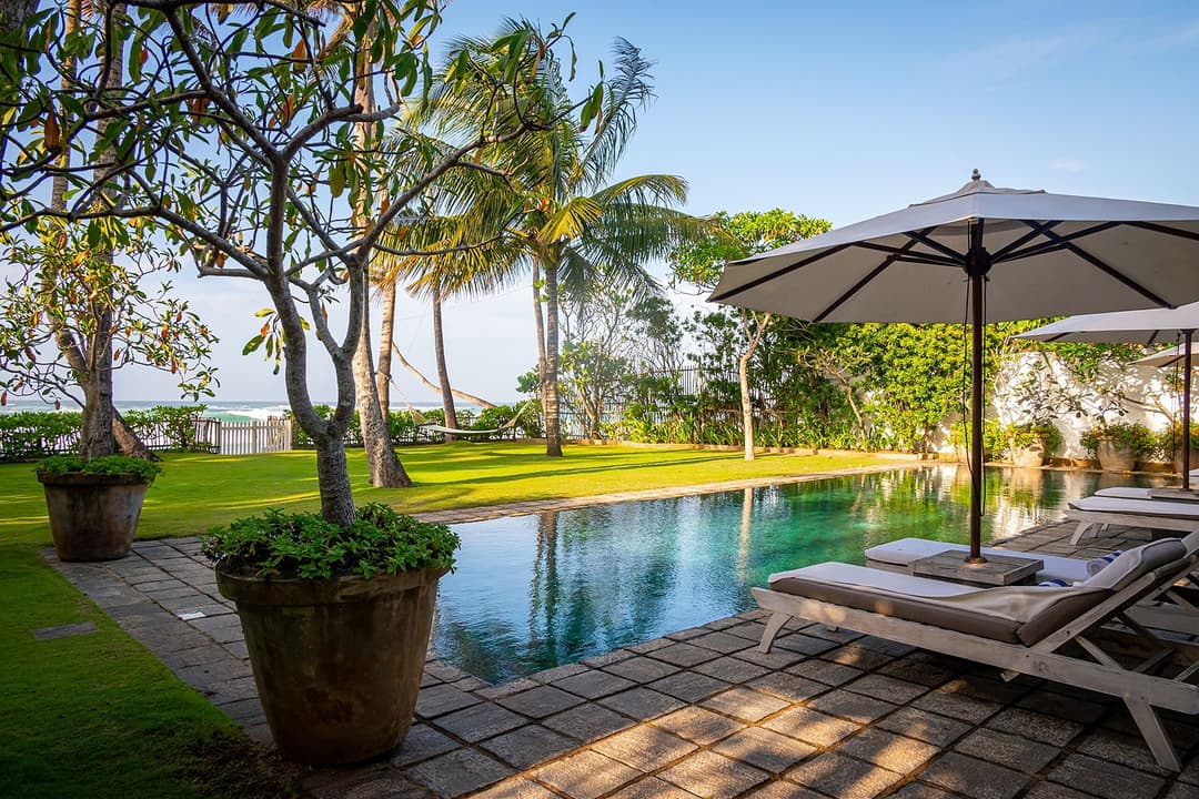 Tide House Habaraduwa pool by day with umbrella and tree