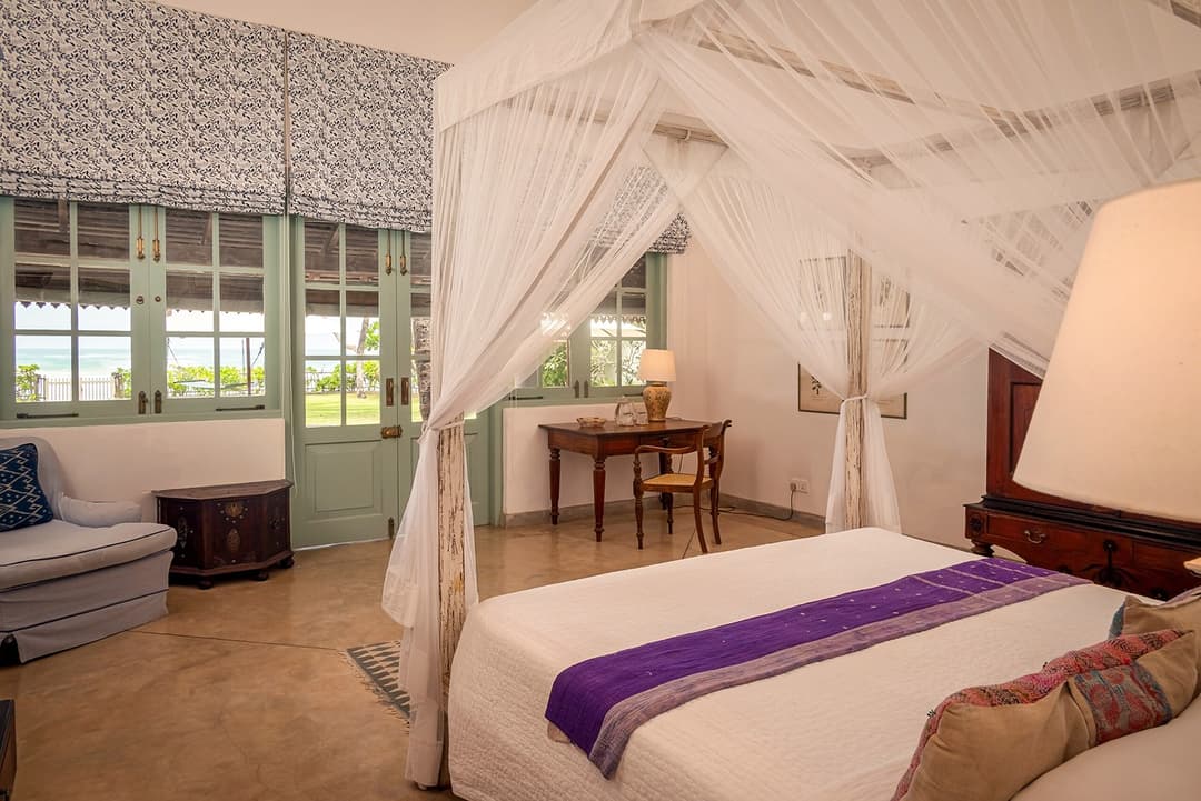 Habaraduwa bedroom with canopy bed and teal shutters
