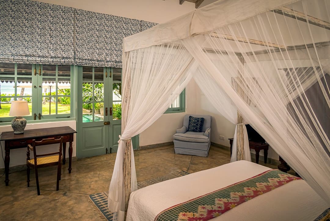 Habaraduwa bedroom canopy bed with teal shutters view