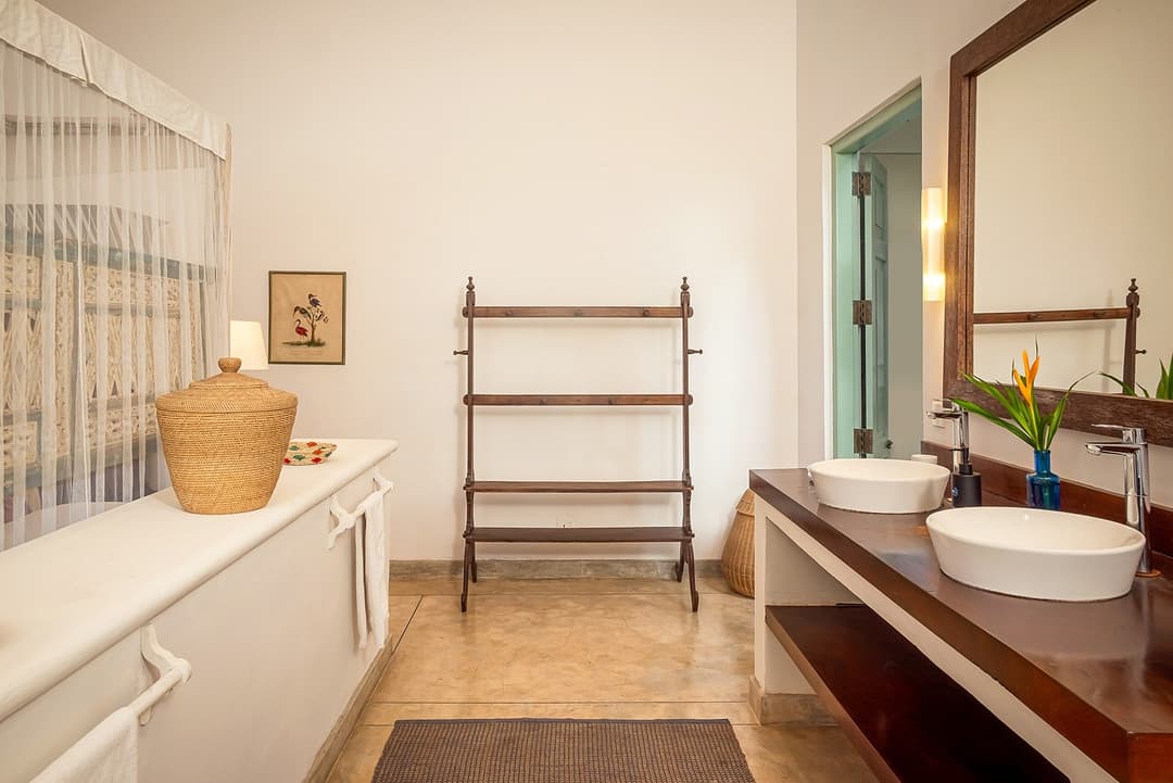 Habaraduwa bathroom with double sink and teal door