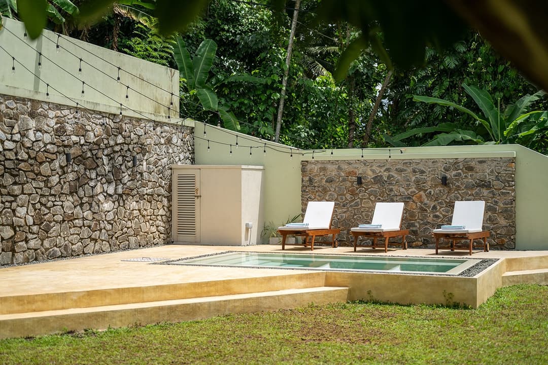 Kanda House Talpe exterior pool patio stone wall