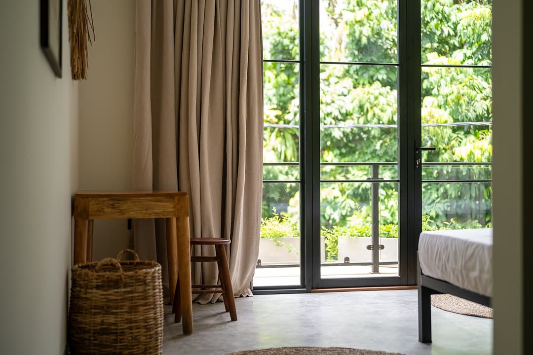 Talpe bedroom with curtain and glass doors