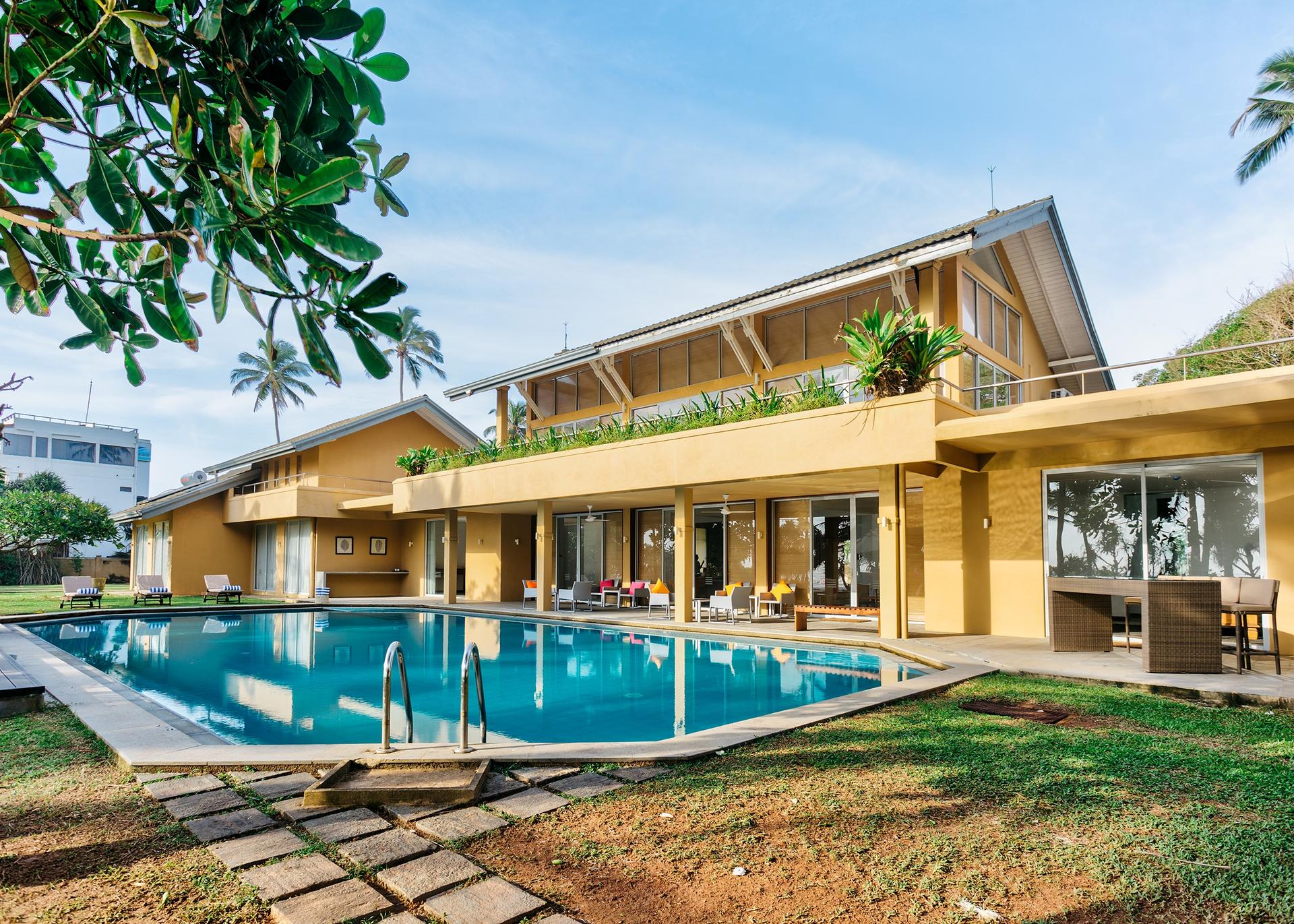 Wadduwa Beach Villa pool and terrace illuminated at evening with warm lighting