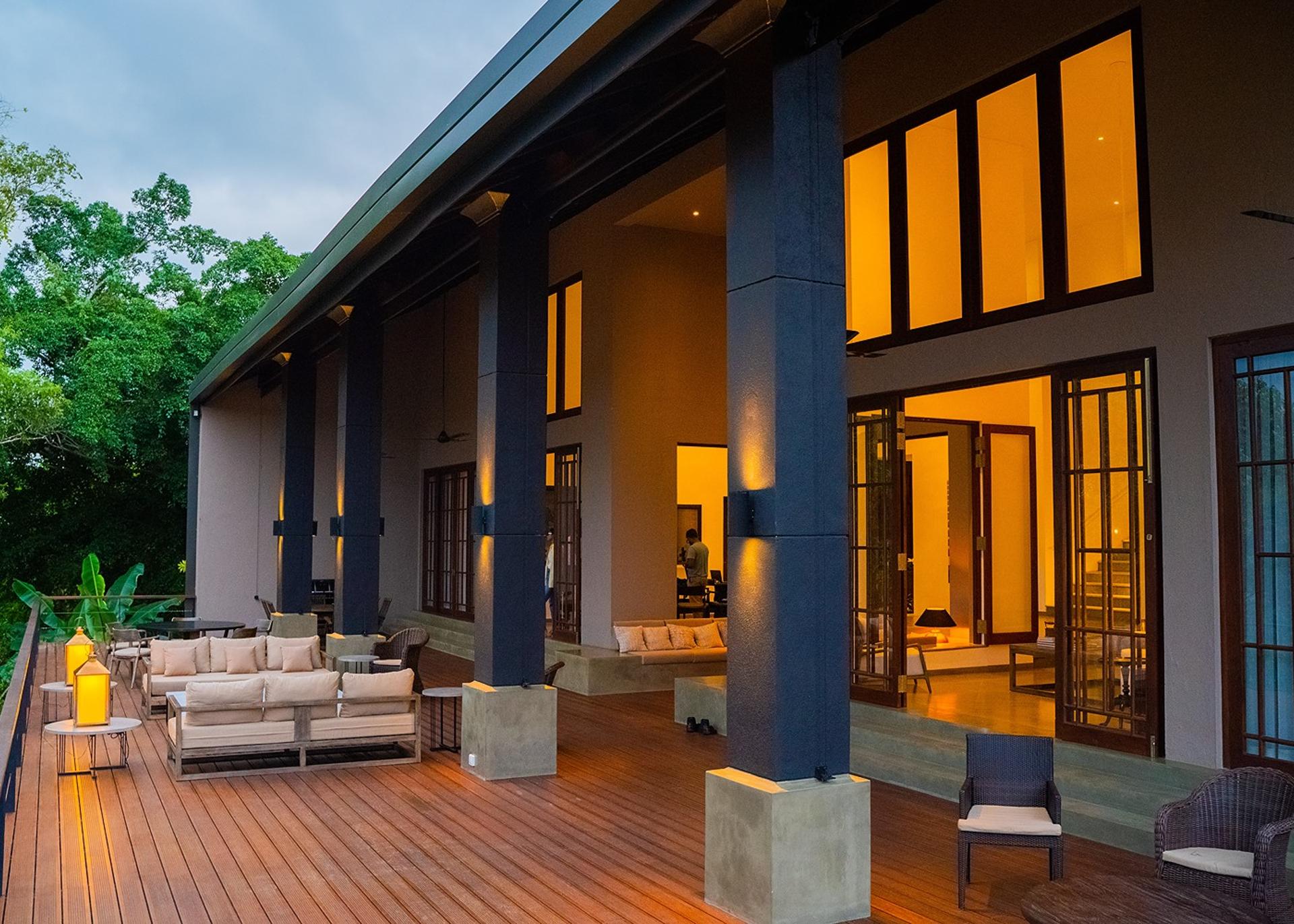 Lily Pod Bolgoda villa exterior with pool and warm facade lighting at evening