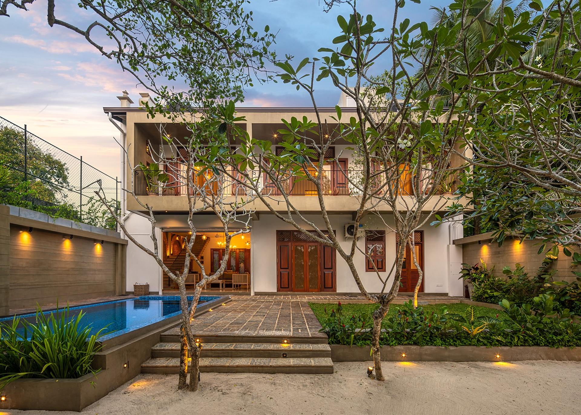 Yahva Bentota villa exterior garden and pool illuminated at dusk