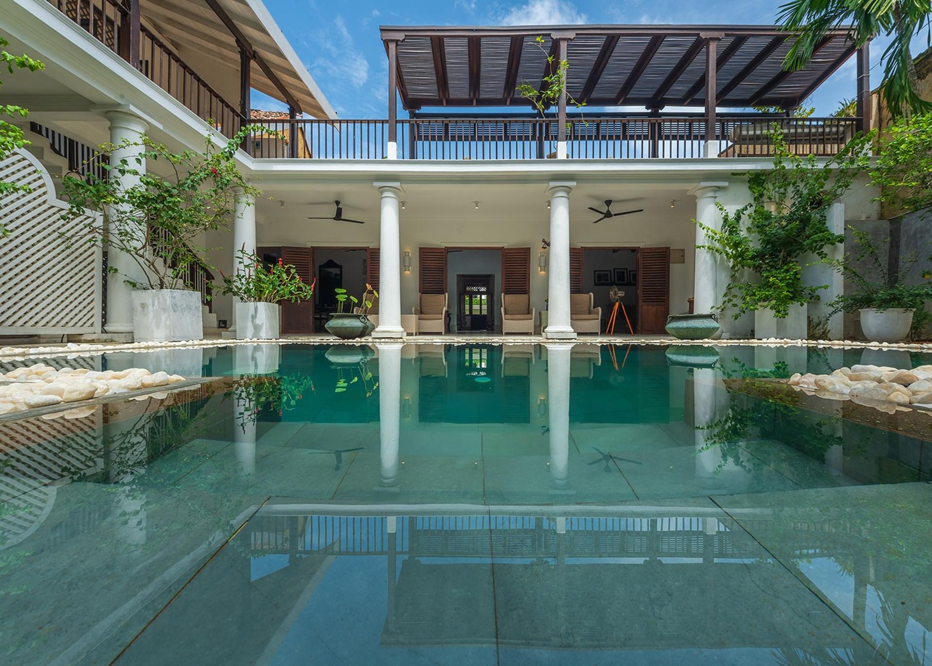 32 Middle Street Galle Fort courtyard pool with white colonial pillars and sun loungers