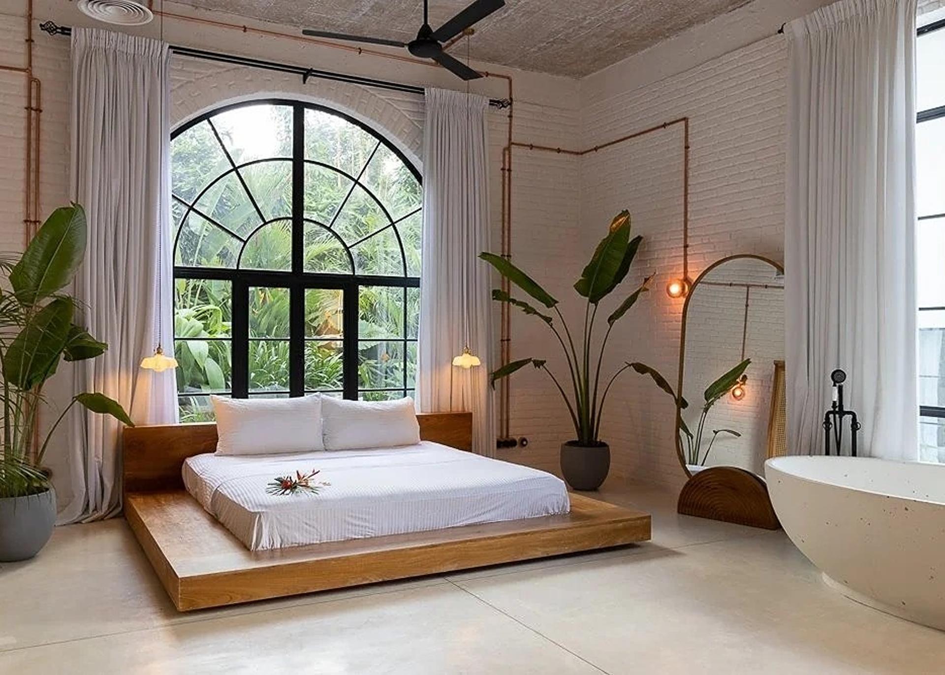 Miss Ceylon Unawatuna King Loft bedroom with large Crittall windows and plants