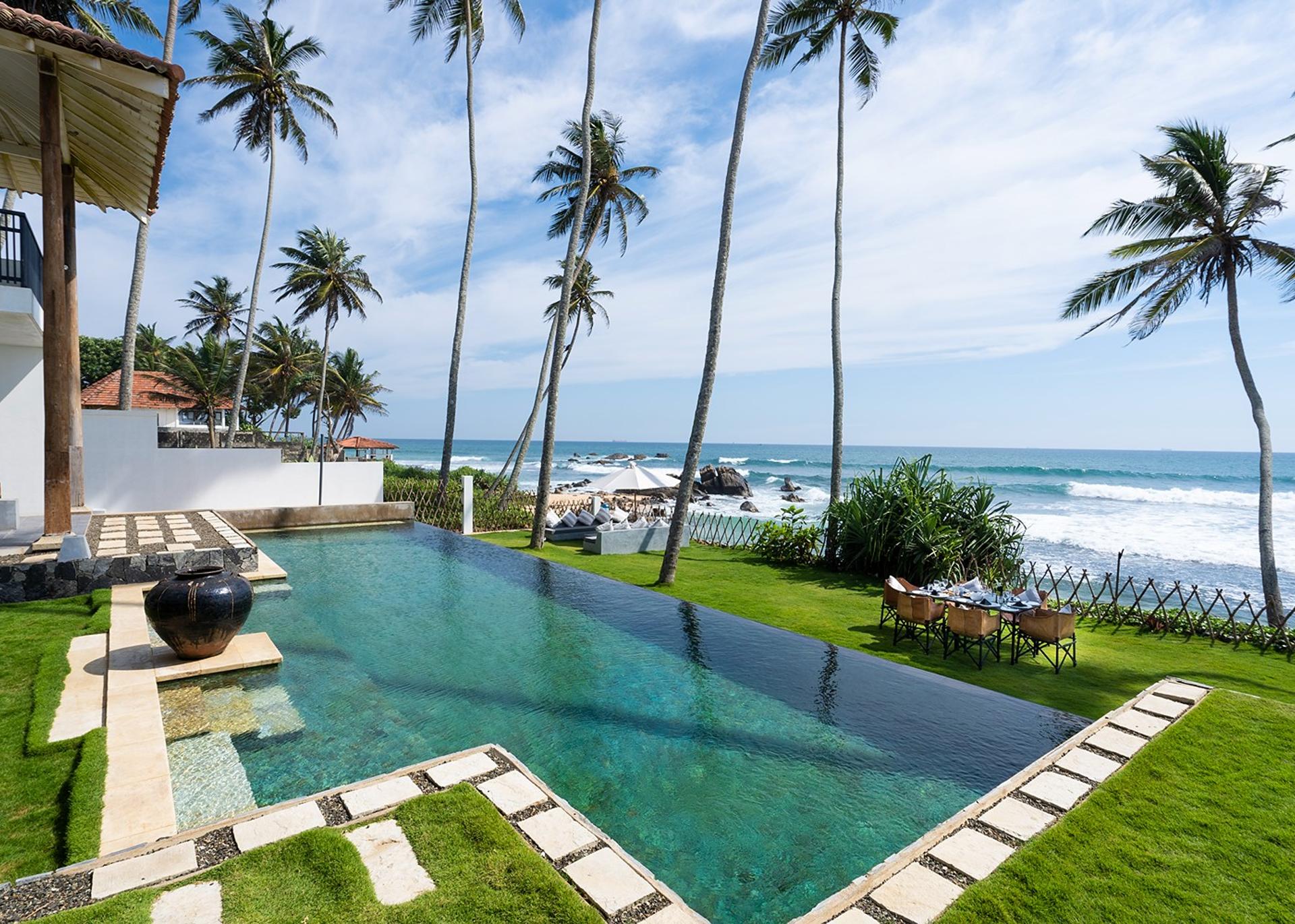 Villa Salt Talpe ground level view of pool, garden and Indian Ocean beyond