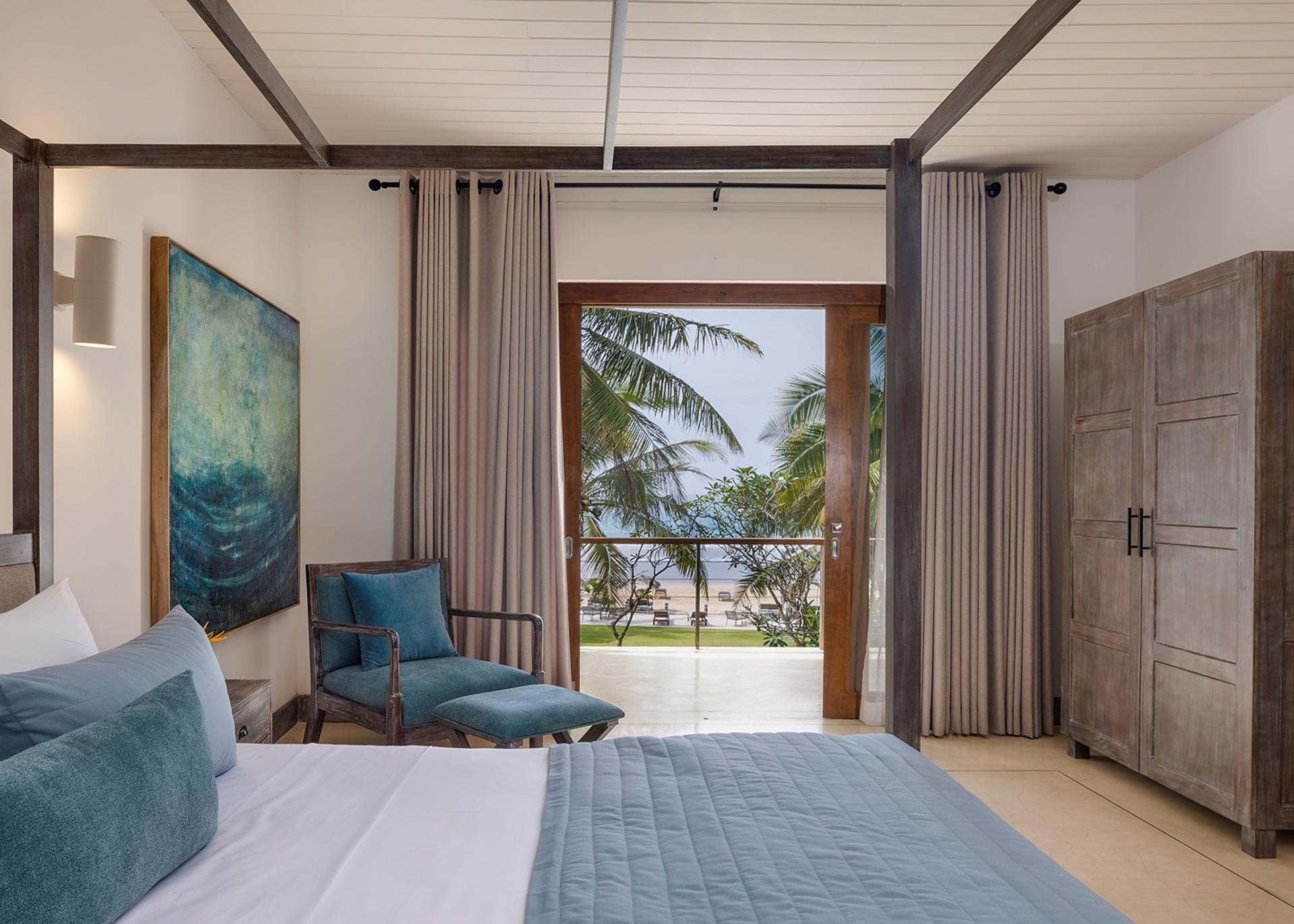 Ahangama beachfront villa bedroom sitting area with blue chair and ocean view