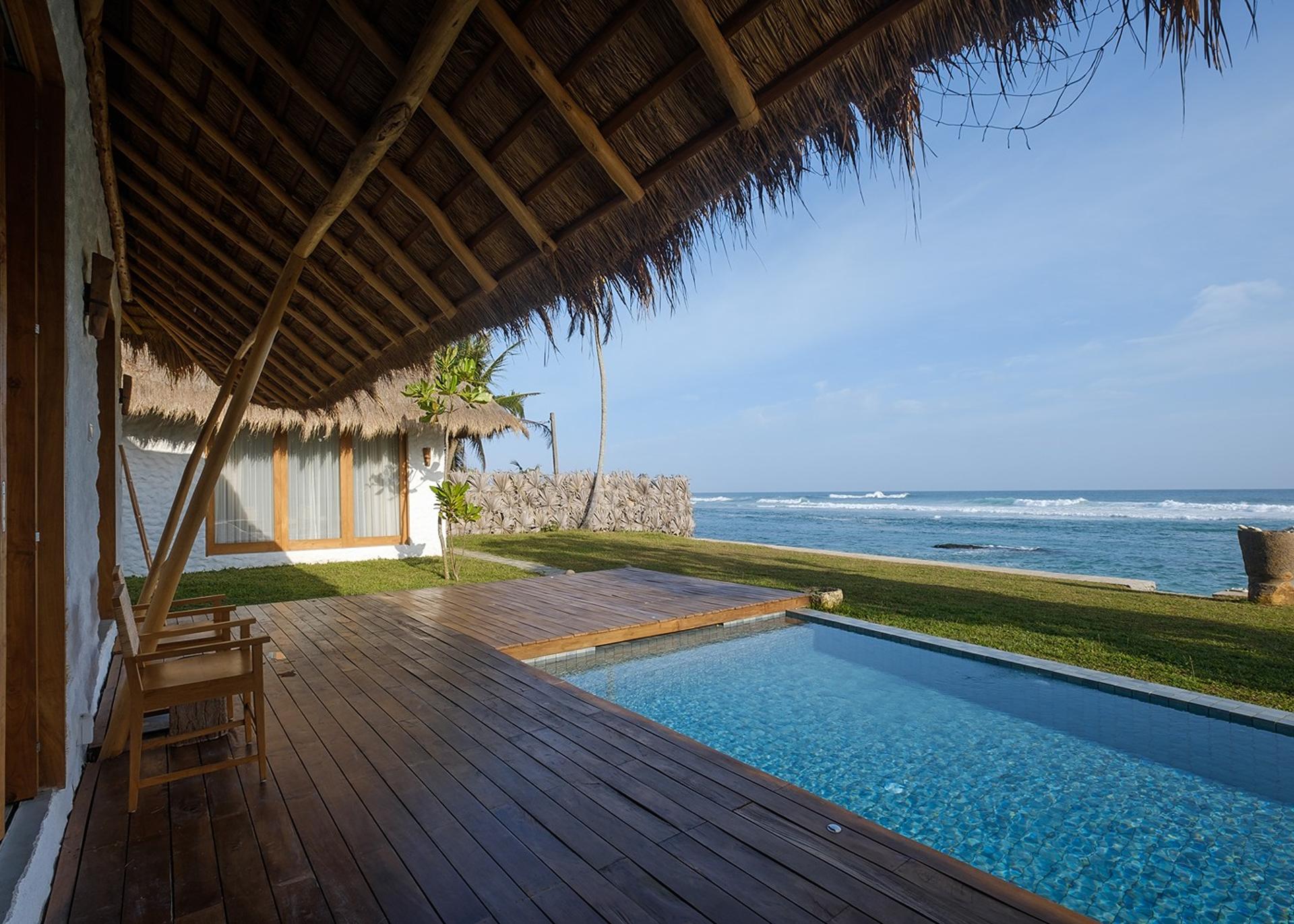 Boho House Mirissa pool on timber deck with Indian Ocean view daytime