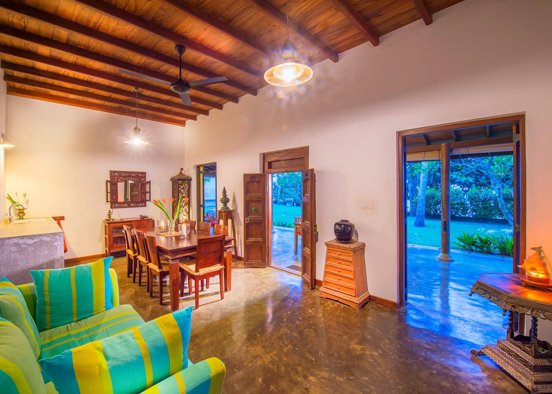 Matara villa living room with green seating and open ocean view wide