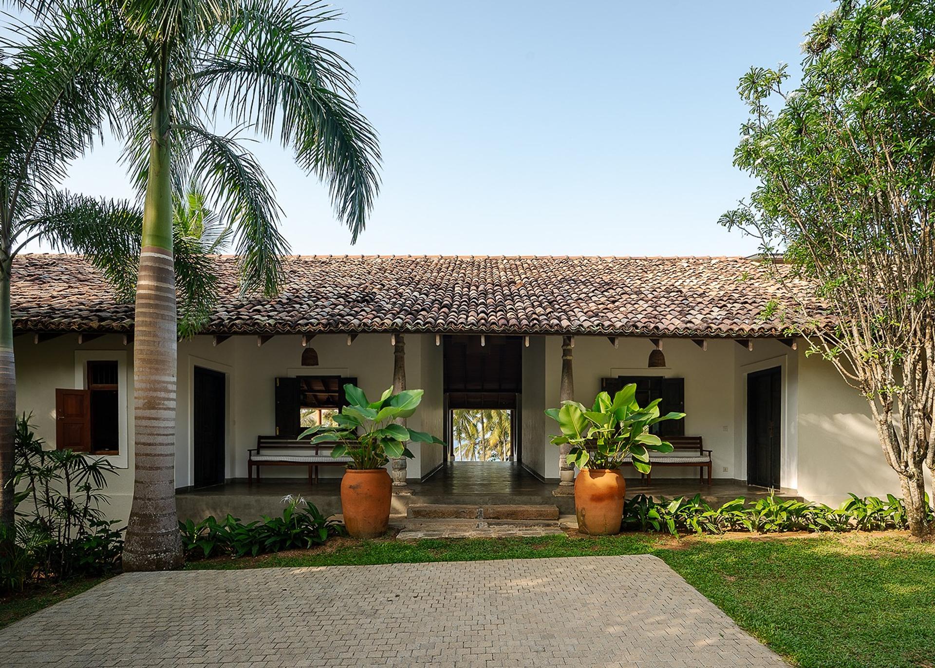 Covered walkway and garden courtyard connecting the two buildings at Pavana Hiriketiya villa