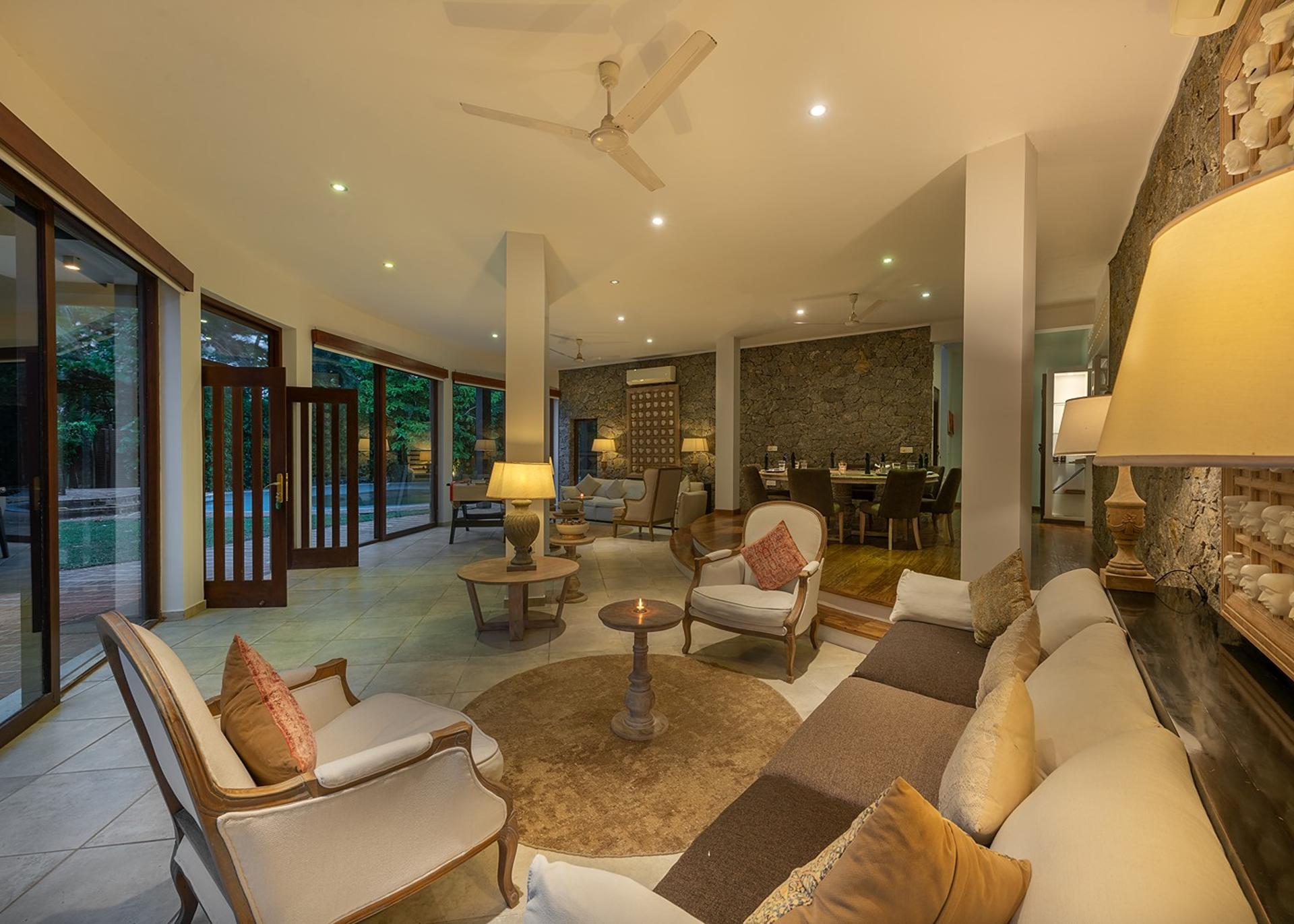 Casa Tua pool terrace illuminated at evening with dining area