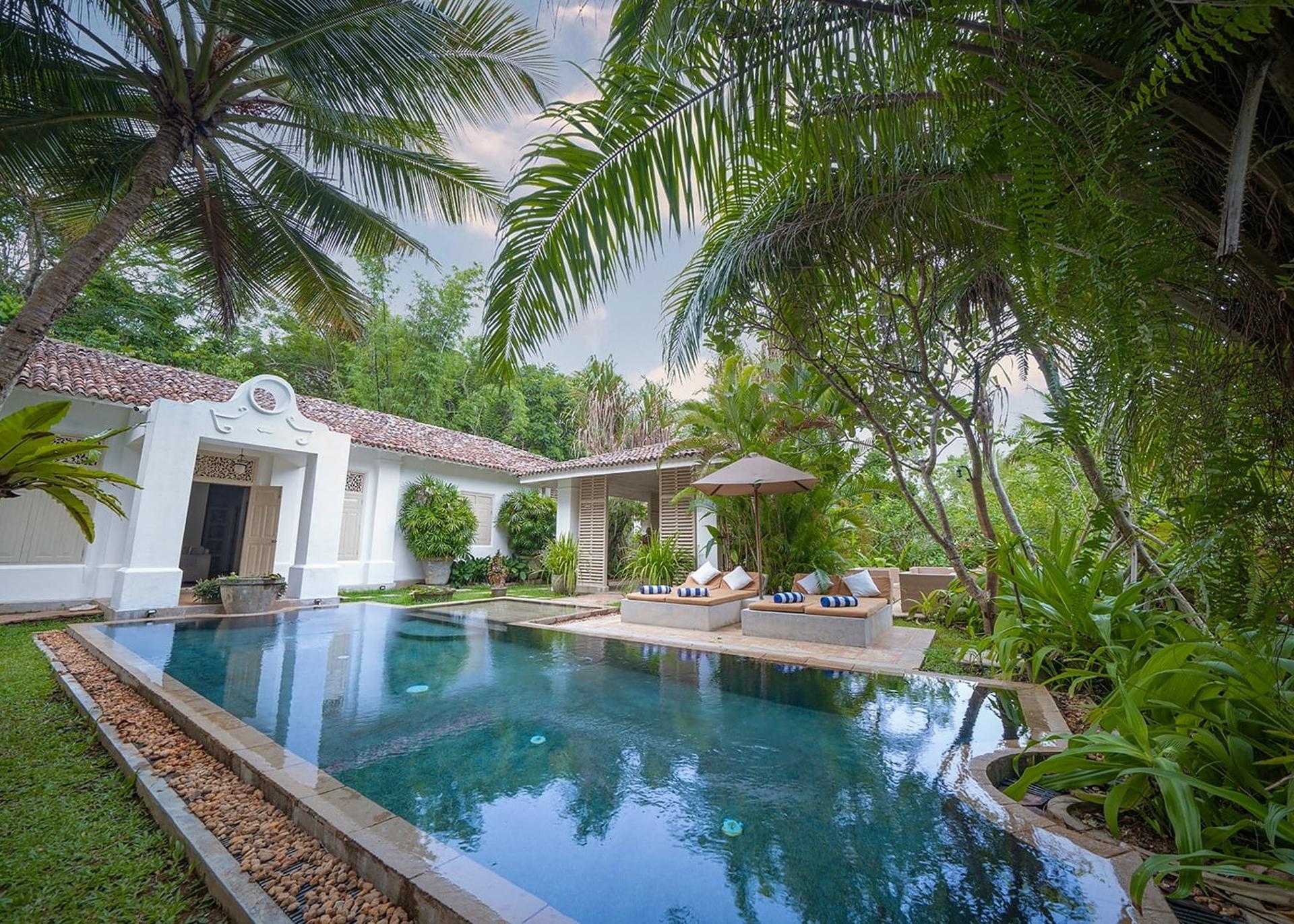 Rivers Edge pool and villa illuminated at evening