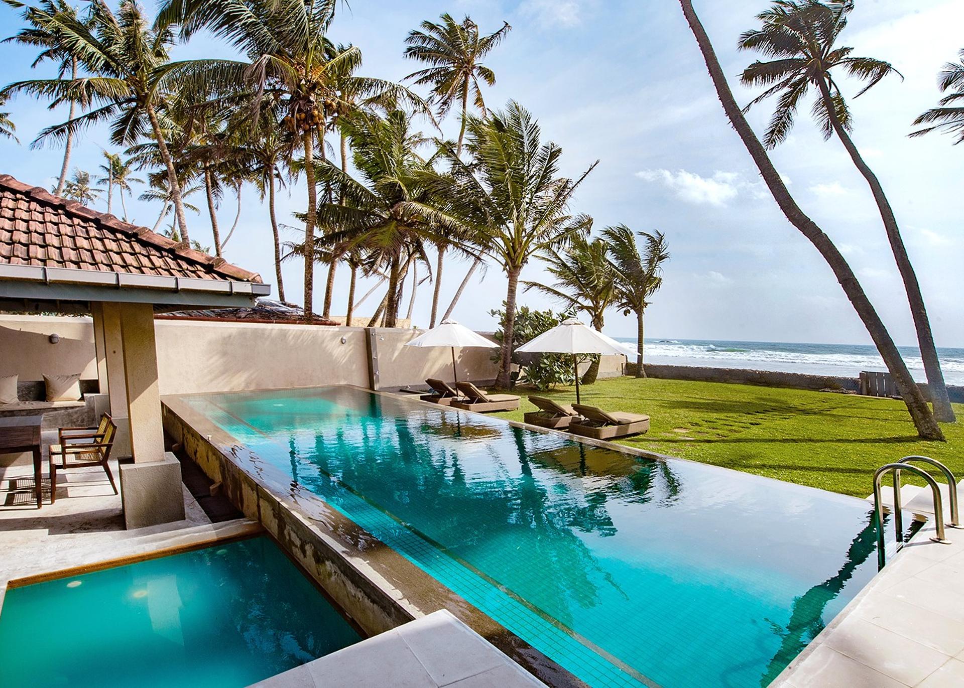Cottage Kabalana pool with coconut palms and beachside pavilion, Ahangama, Sri Lanka