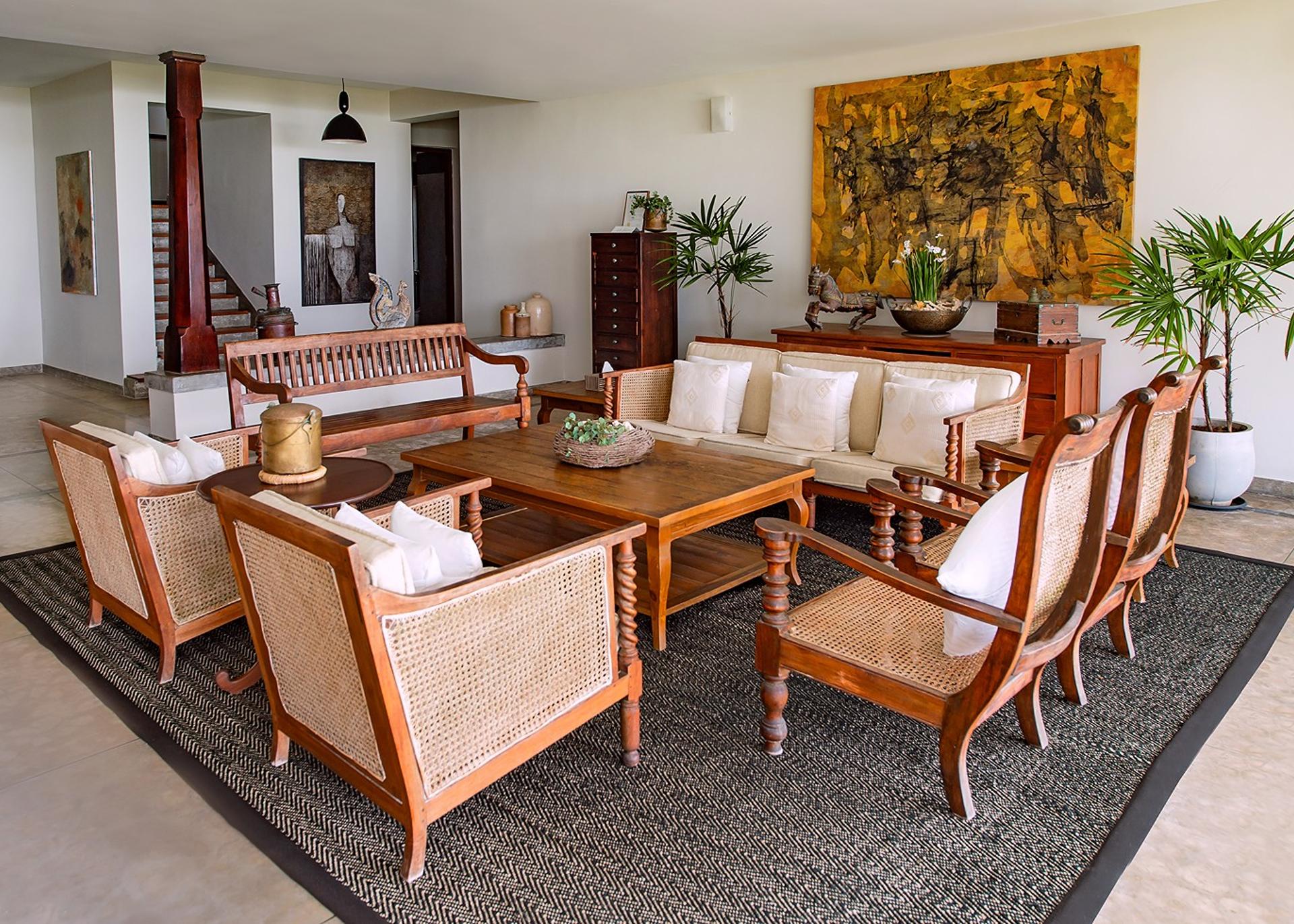 Living room with large abstract artwork and colonial seating at Cottage Kabalana, Ahangama