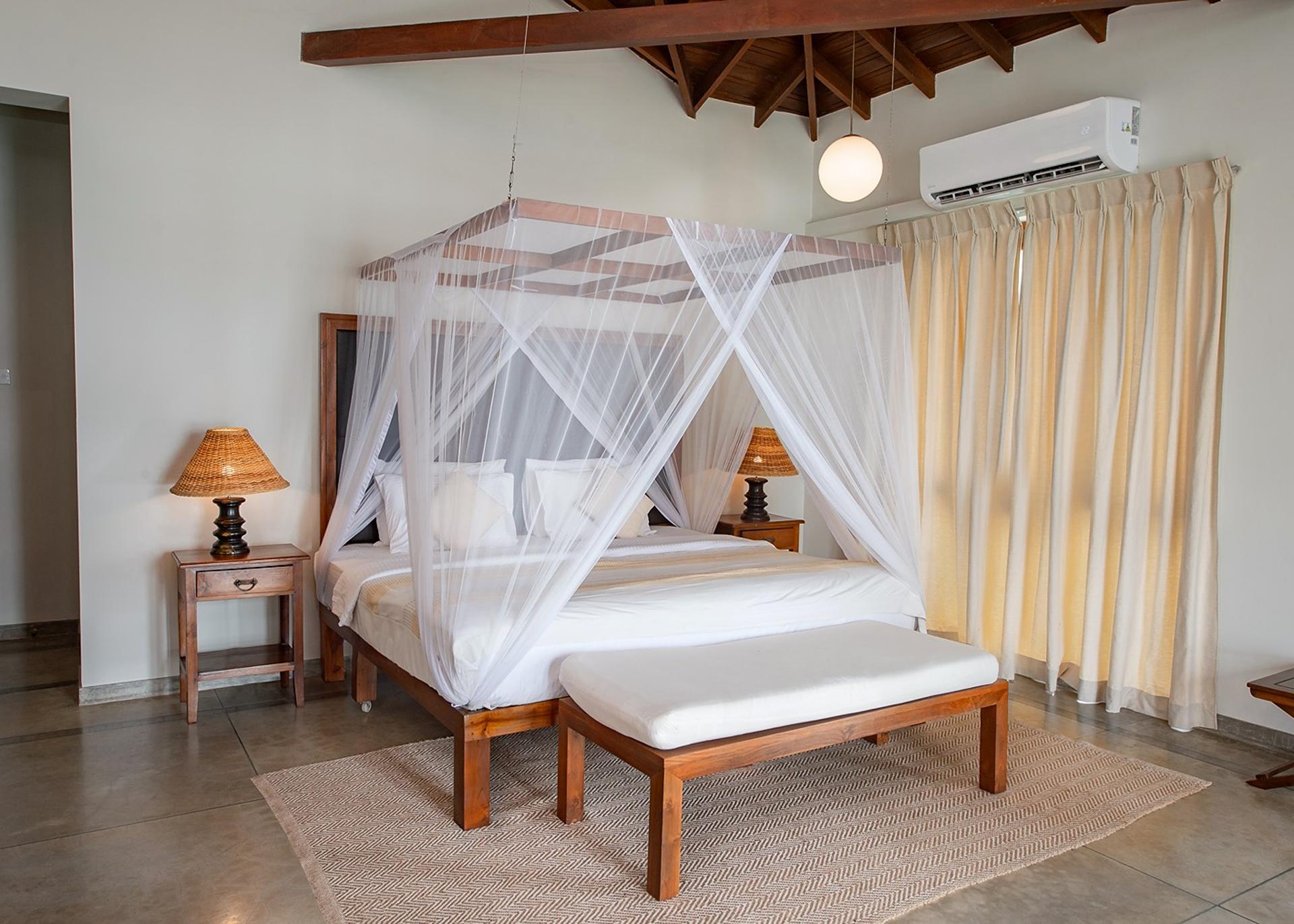 Cottage Kabalana bedroom with four-poster canopy bed and cream coastal tones, Ahangama