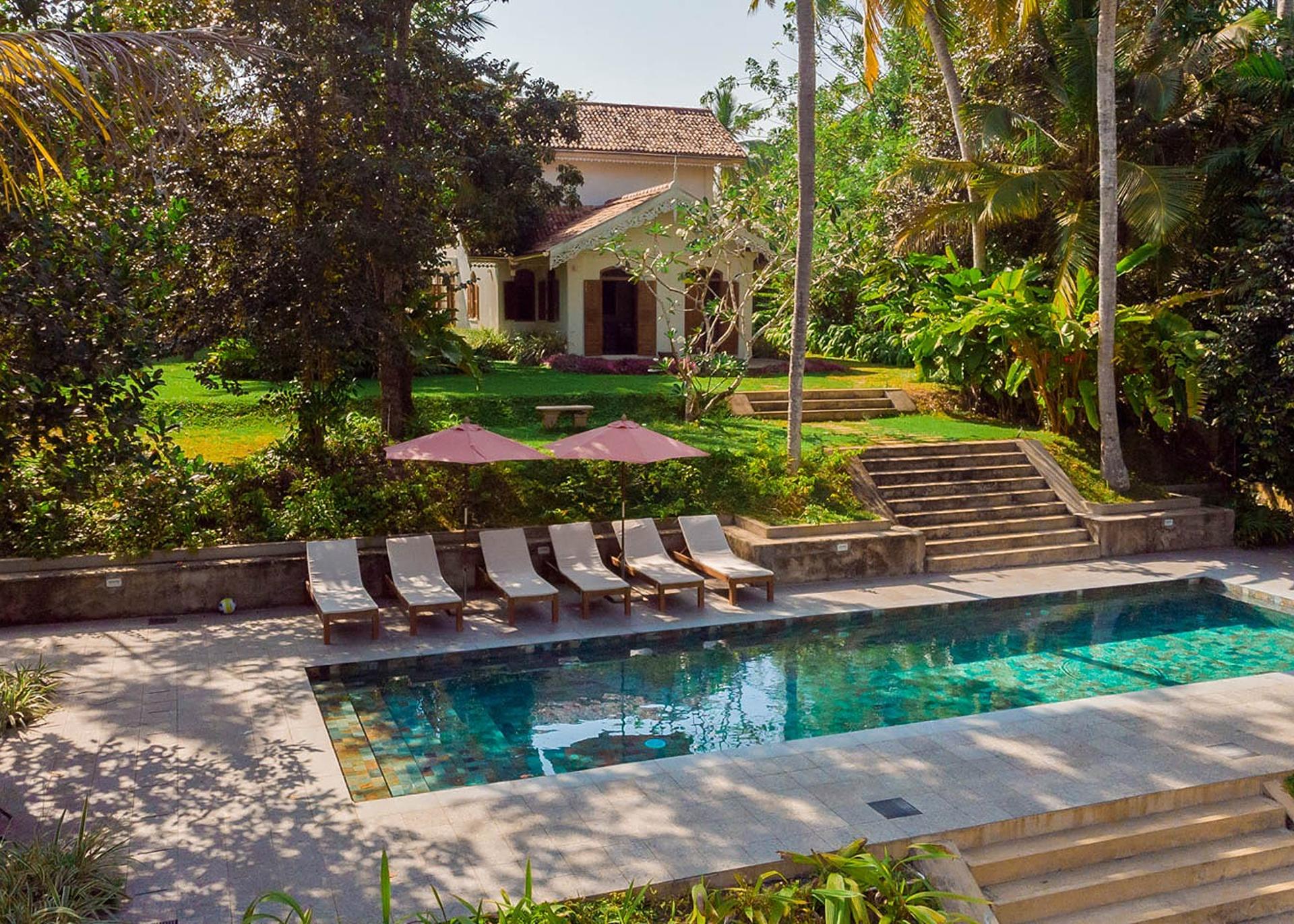 Aerial side angle of Island Villa Ahangama pool in tropical garden, Ahangama, Sri Lanka