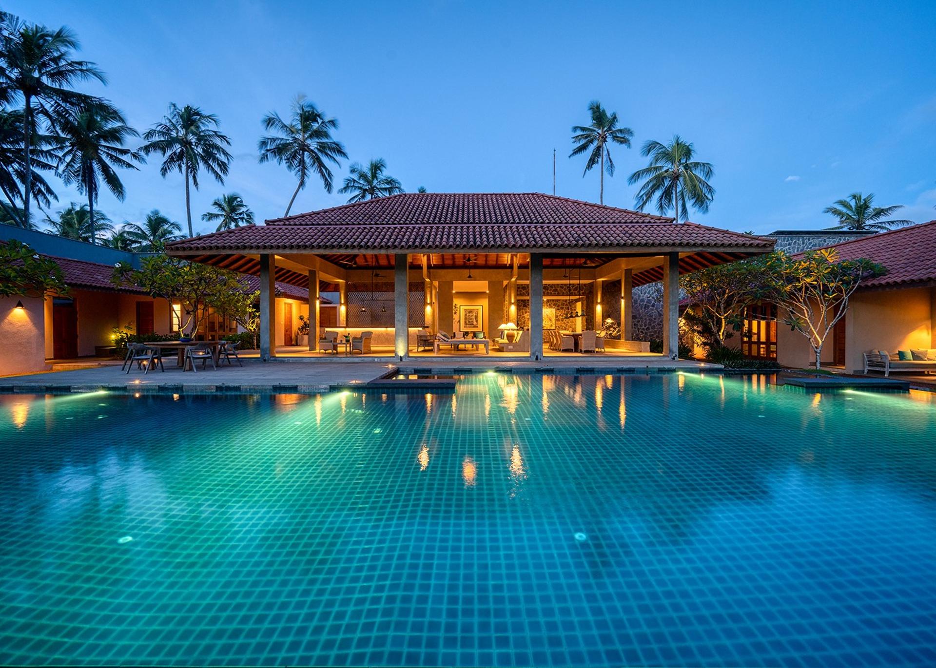 Kirana Villa Bentota exterior and pool illuminated at blue hour dusk, Sri Lanka