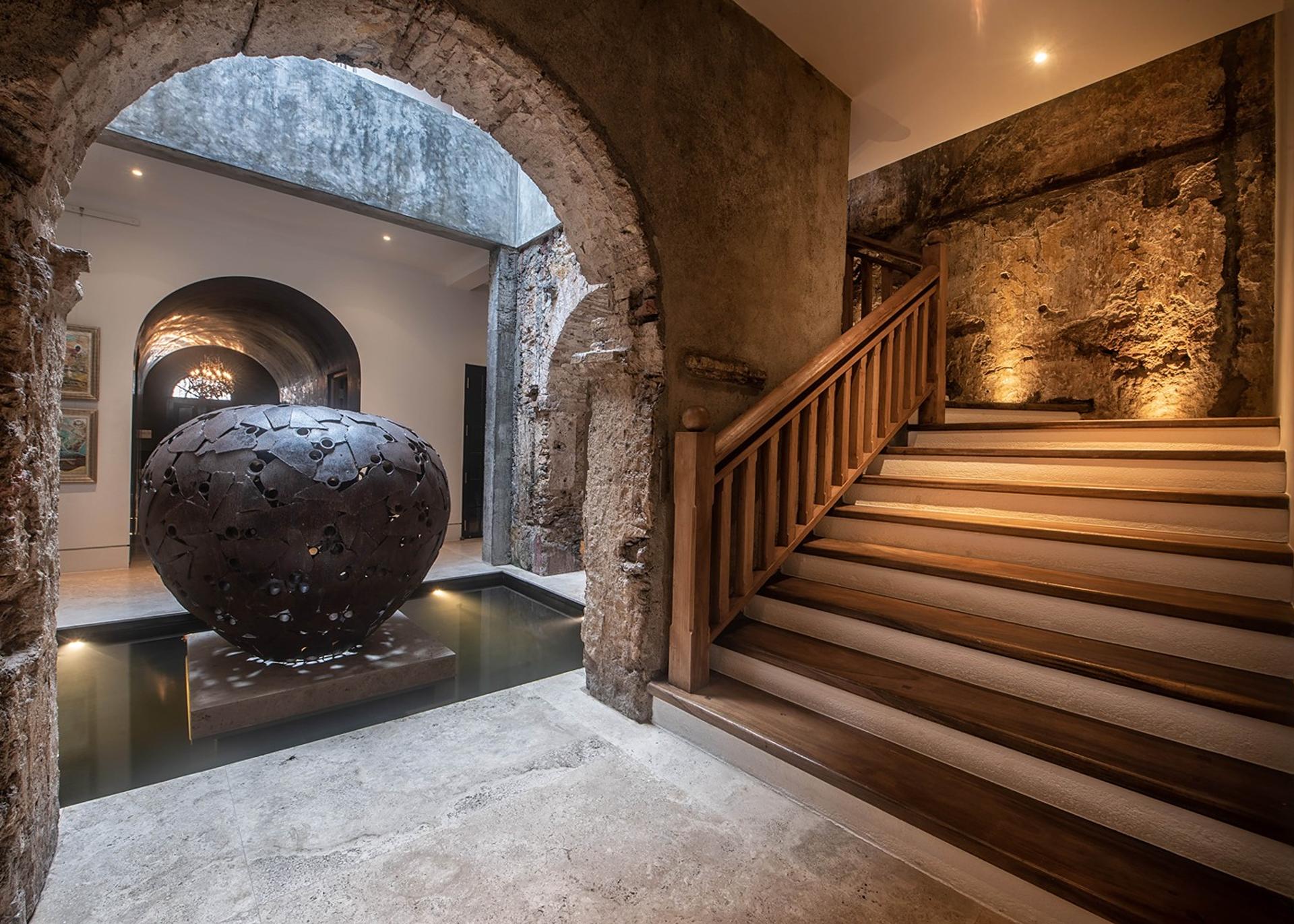 Lit staircase with urn sculpture at base and arched corridor, No. 77 Leyn Baan, Galle Fort