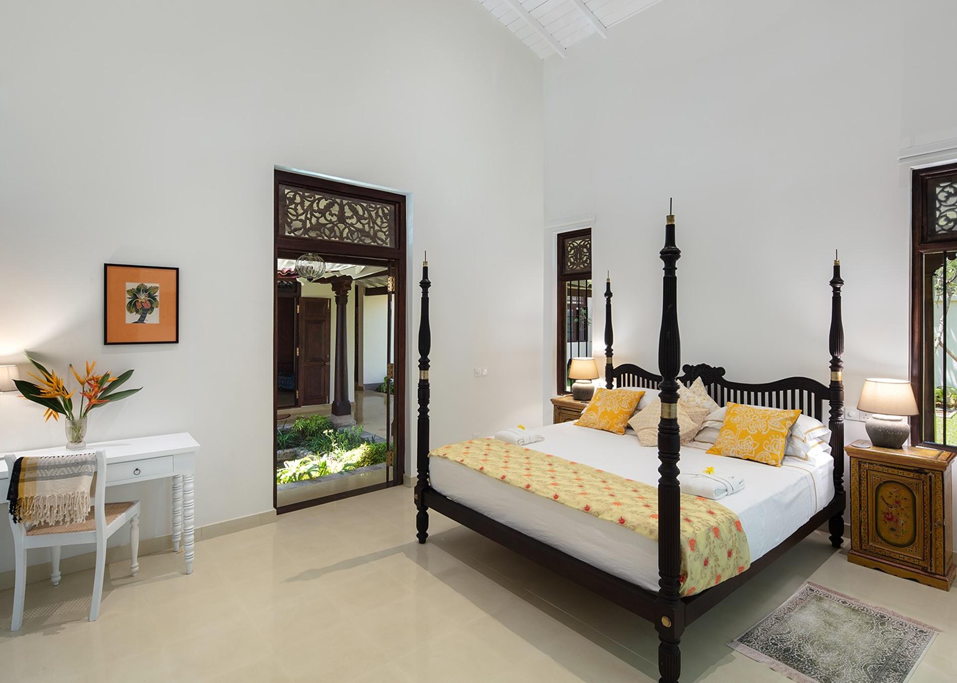 Four-poster king bedroom open to garden and sea at Abiman, Dickwella, Sri Lanka