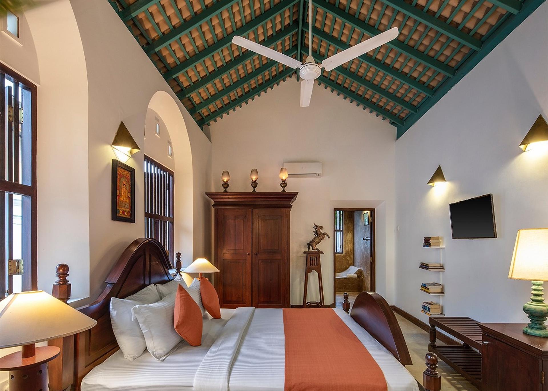 Bedroom one with orange bed wide view, Magalla Casa Galle