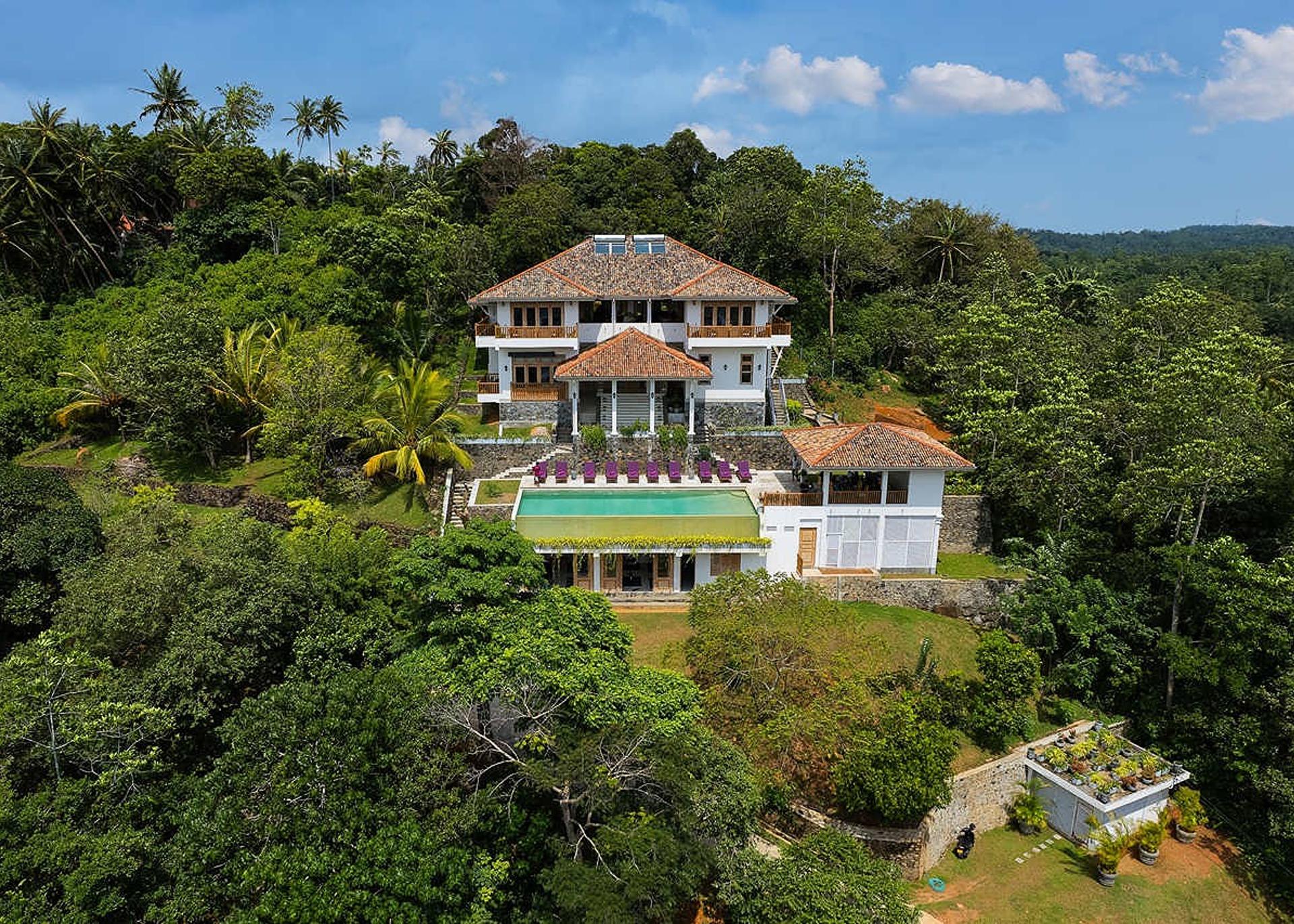 Aerial daytime view over paddy and forest, Divine Villa Talpe