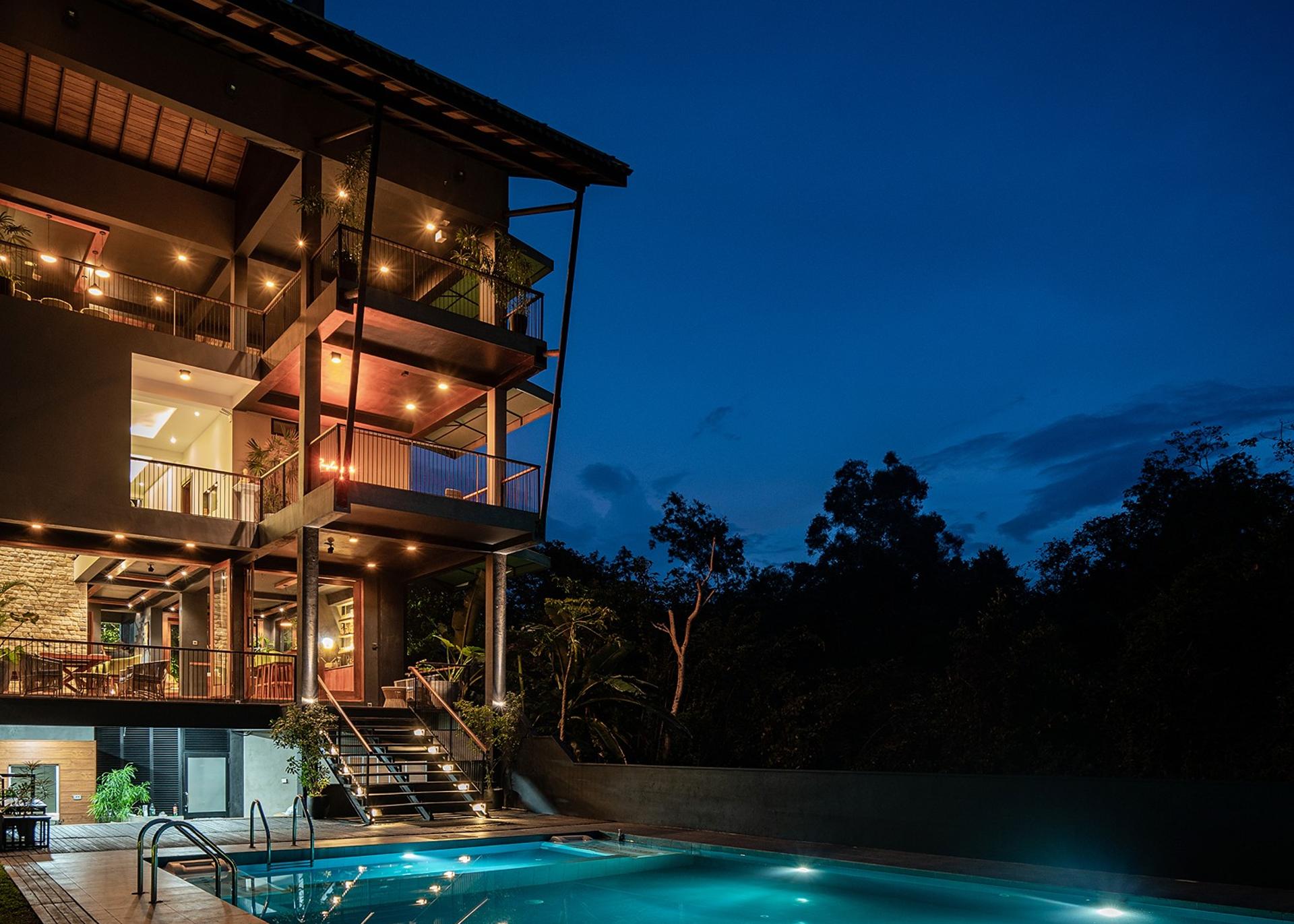 Villa exterior lit at night with pool, Kurokawa Kalutara