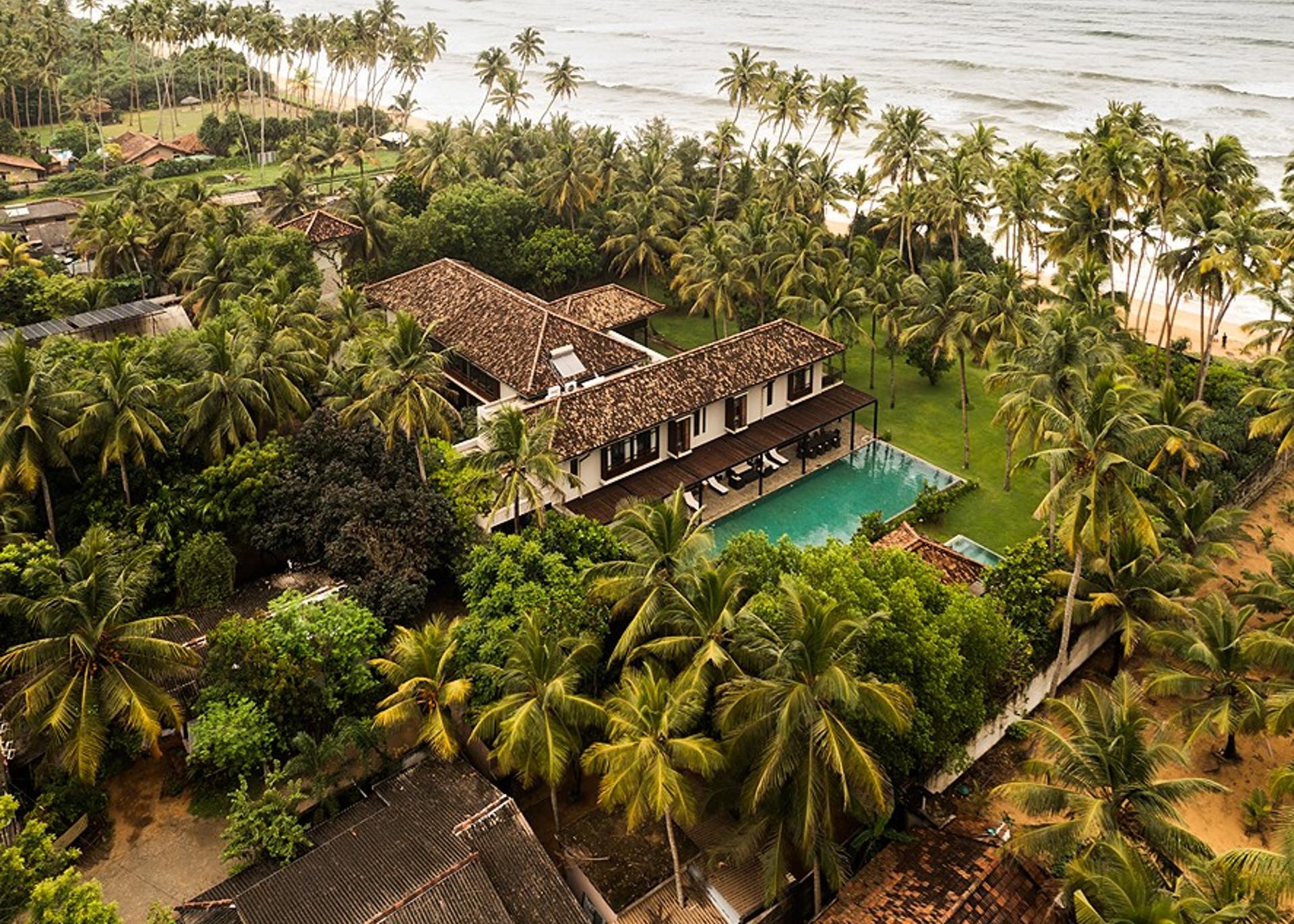 Aerial villa surrounded by palms, The Villa by CC Wadduwa